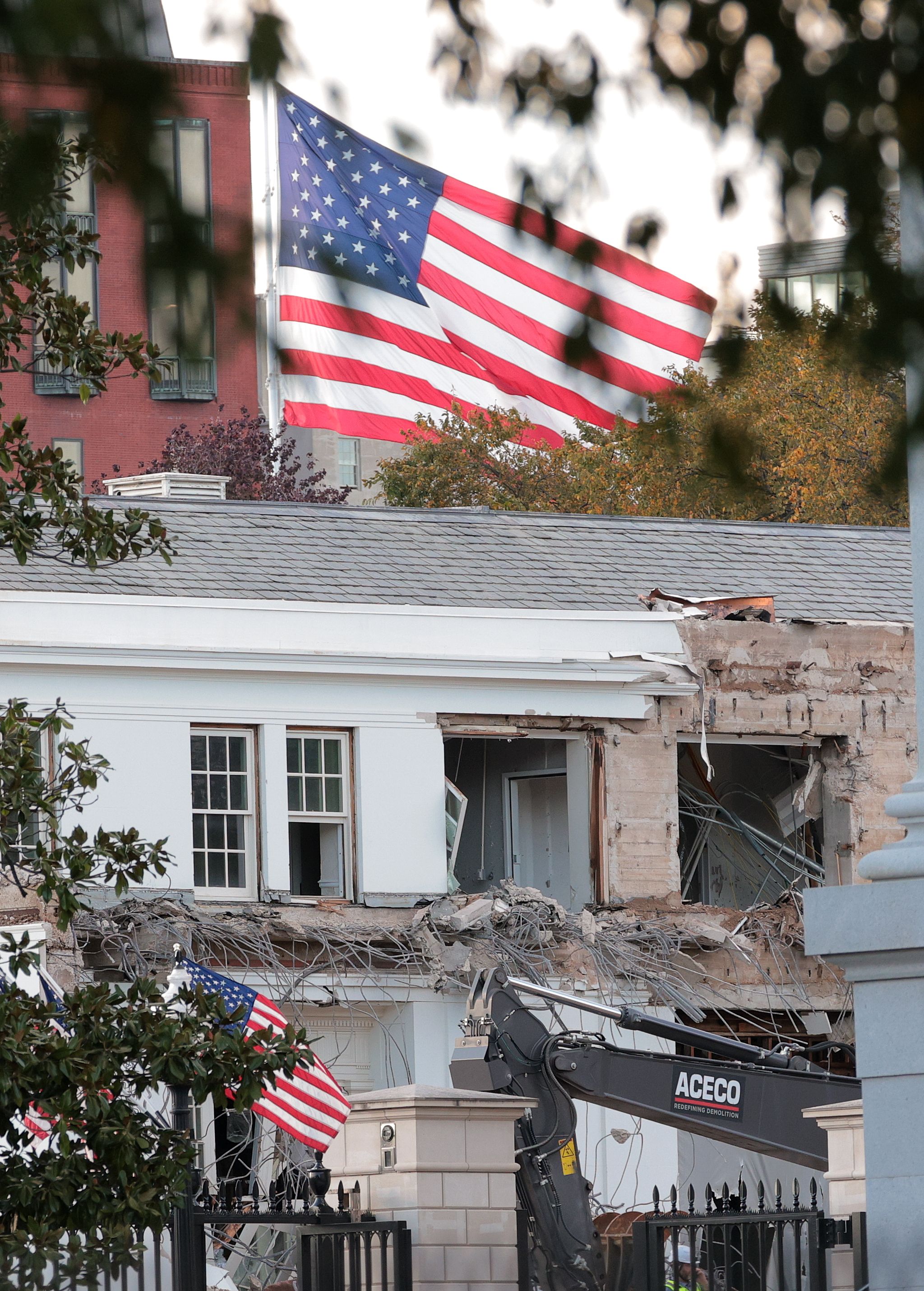 Workers demolish the facade of the East Wing of the White House yesterday.