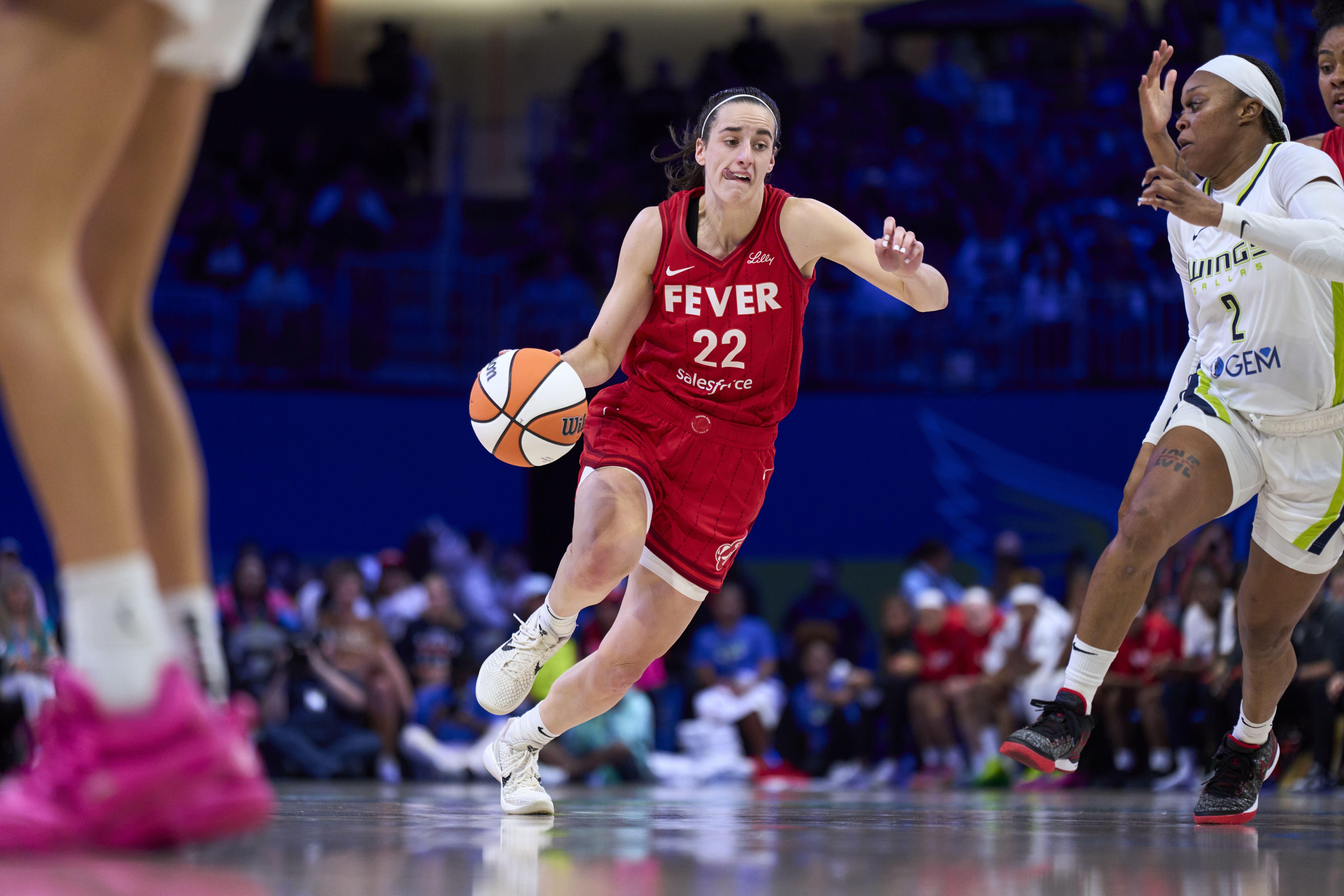 ARLINGTON, TEXAS - JULY 17: Caitlin Clark #22 of the Indiana Fever drives to the basket against the Dallas Wings at the College Park Center on July 17, 2024 in Arlington, Texas. NOTE TO USER: User expressly acknowledges and agrees that, by downloading and or using this photograph, User is consenting