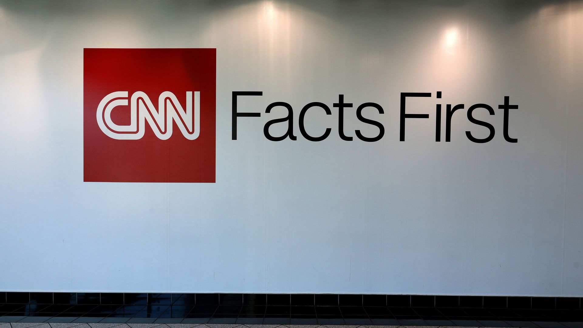 "CNN, Facts First" is written on a white wall. 
