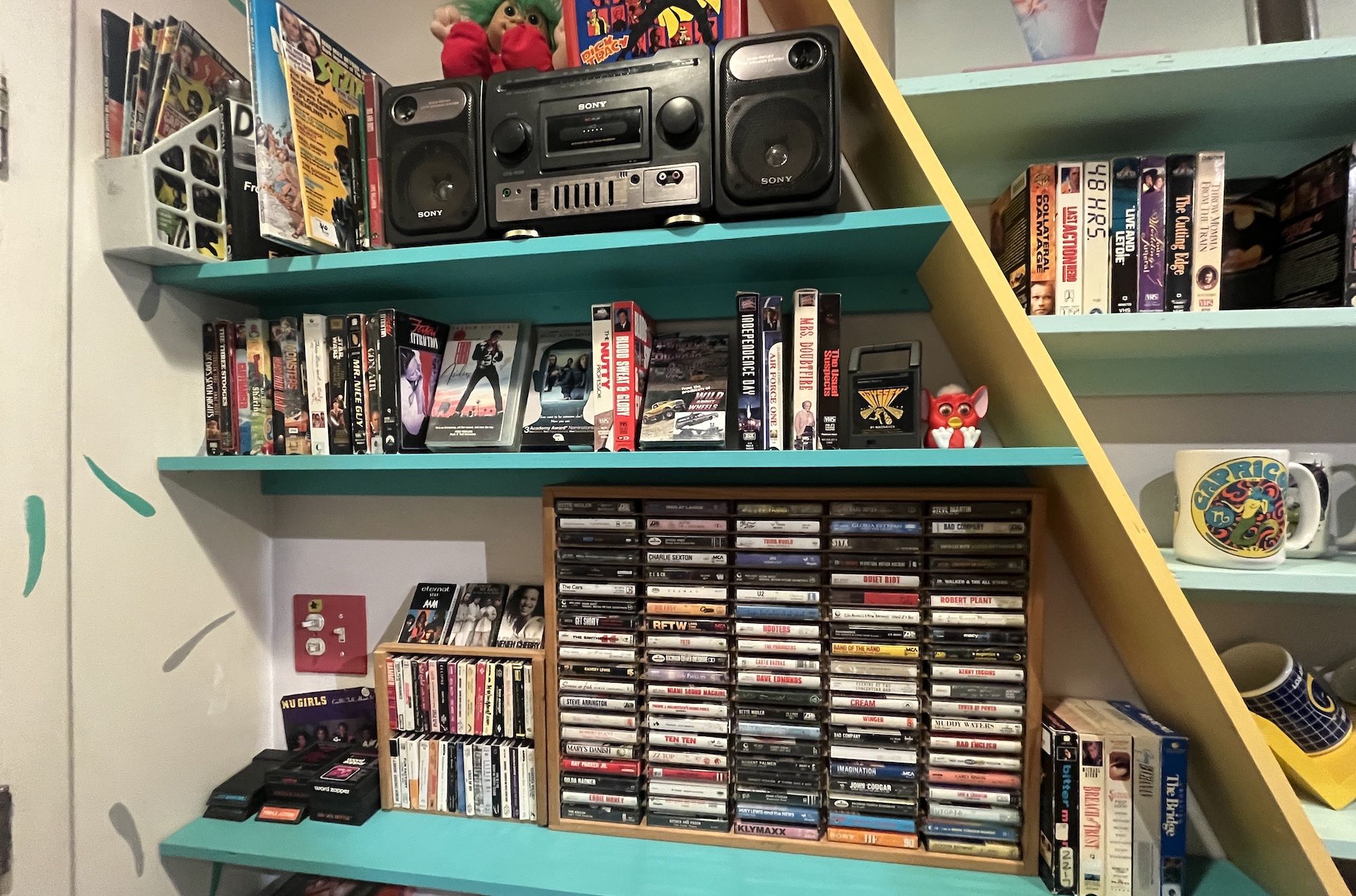 wall with cassette tapes and a boom box.