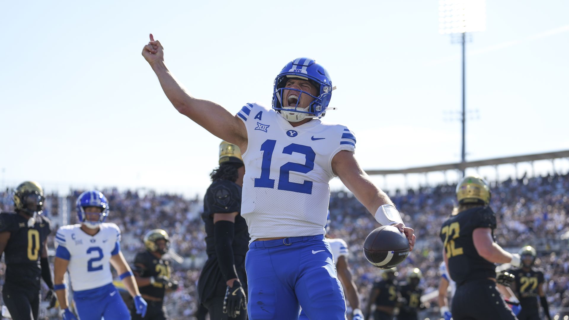 A player in a white and blue uniform celebrates