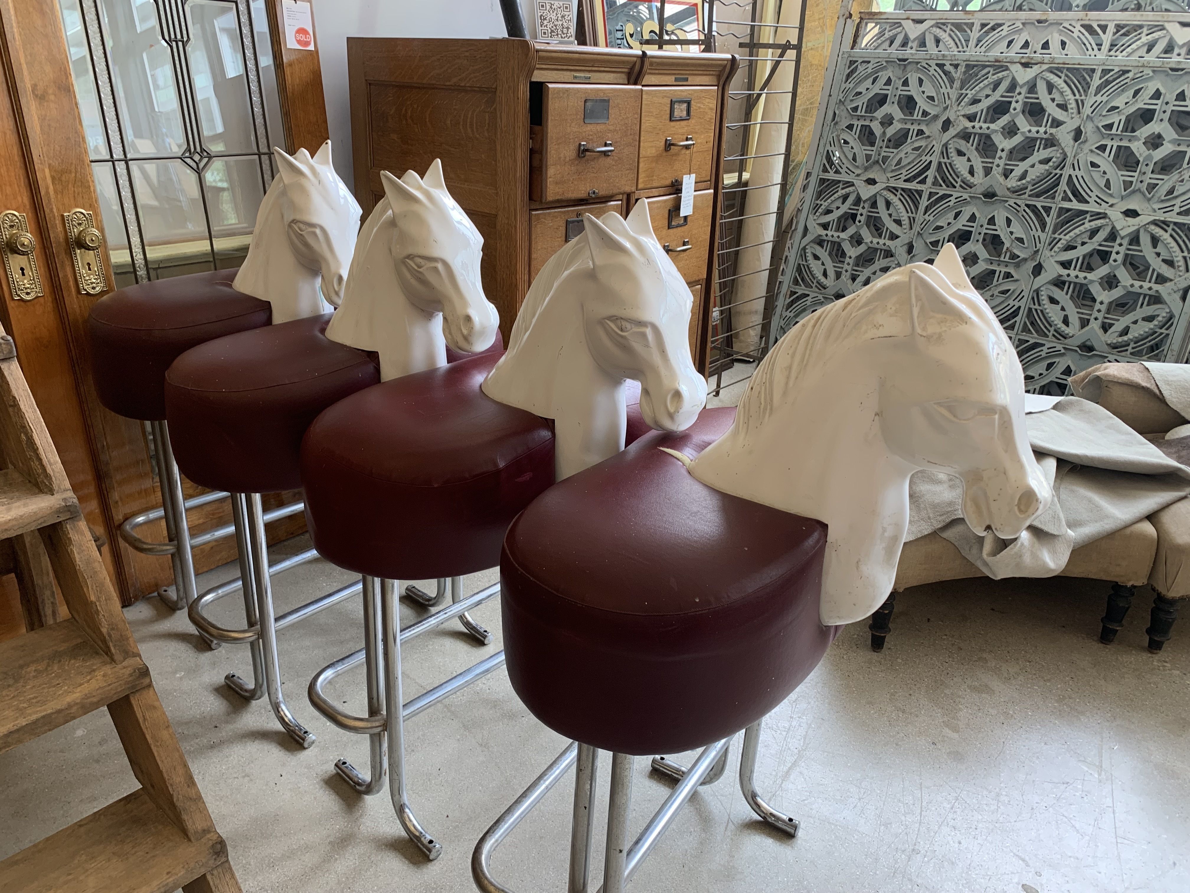 Photo of stools with horse heads on them. 