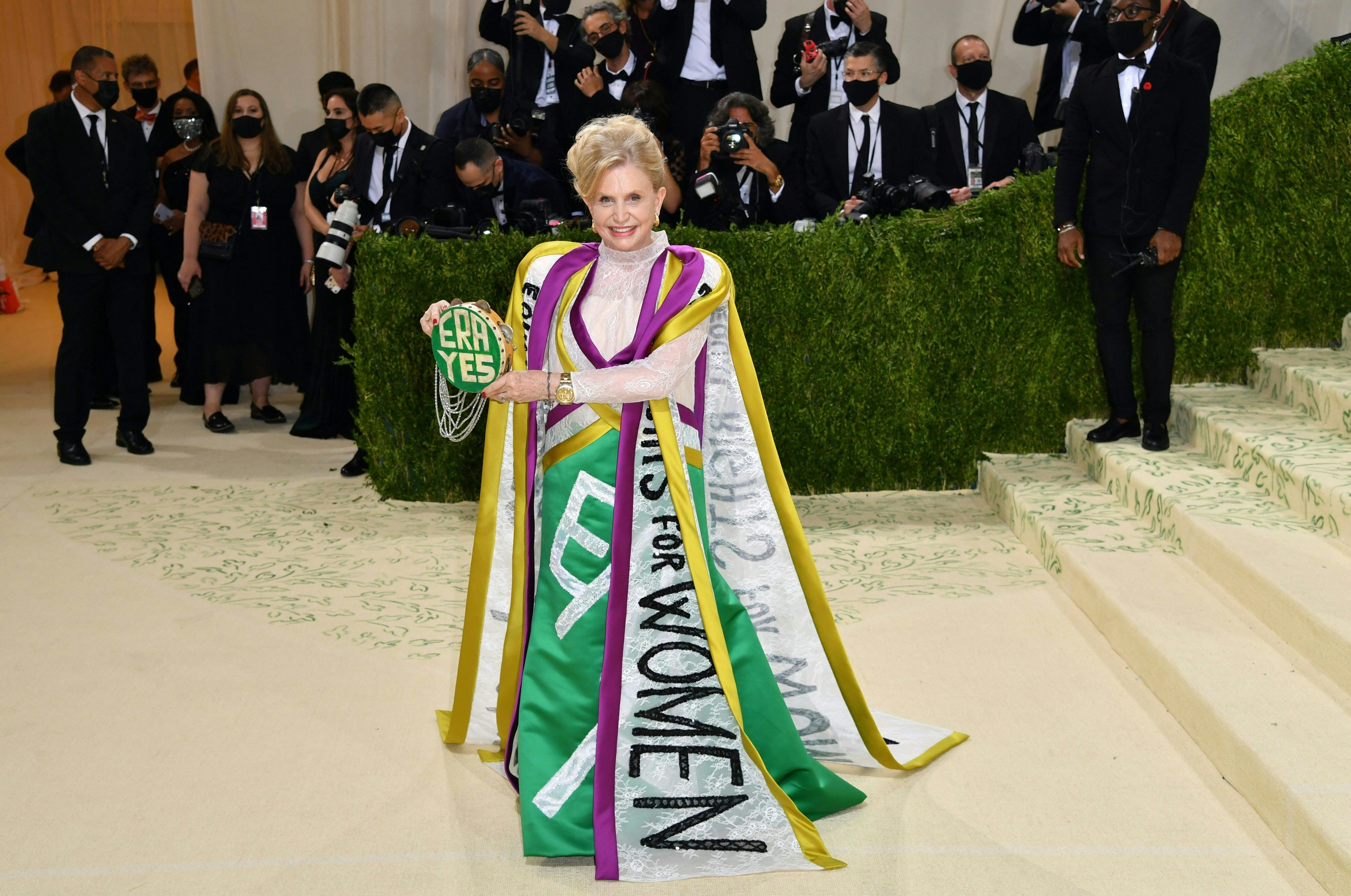 Rep. Carolyn Maloney wears a gown displaying the purple, white and gold colors of the suffrage movement, with sashes stating "equal rights for women" at NYC's Met Gala on Monday.