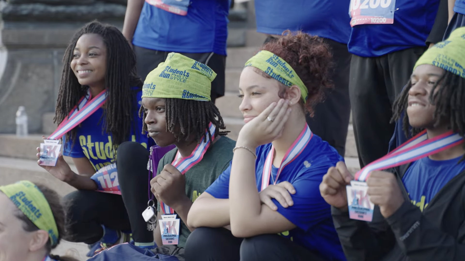 Students flashing their medals after completing the MileUp program.