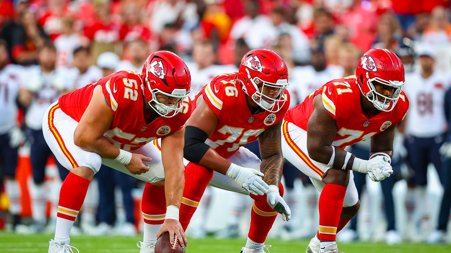 Creed Humphrey #52 of the Kansas City Chiefs, Kingsley Suamataia #76 of the Kansas City Chiefs, and Josh Simmons #71 of the Kansas City Chiefs prepare to block during the first quarter of the NFL Preseason 2025 game between the Chicago Bears and the Kansas City Chiefs.