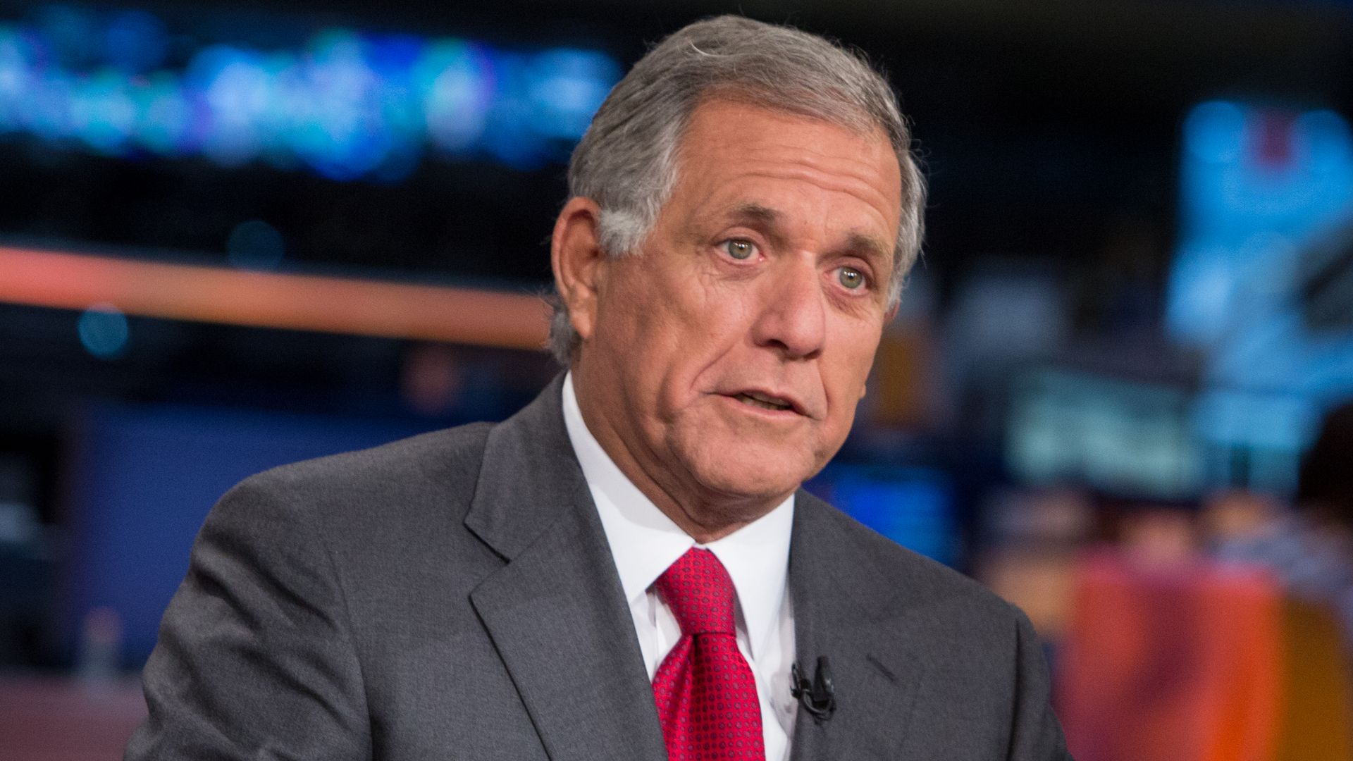 LEs Moonves wearing a gray suit and red tie.