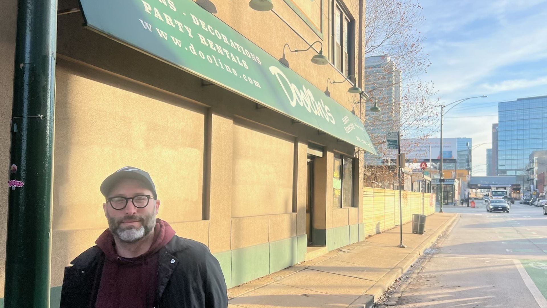 man in front of boarded up building