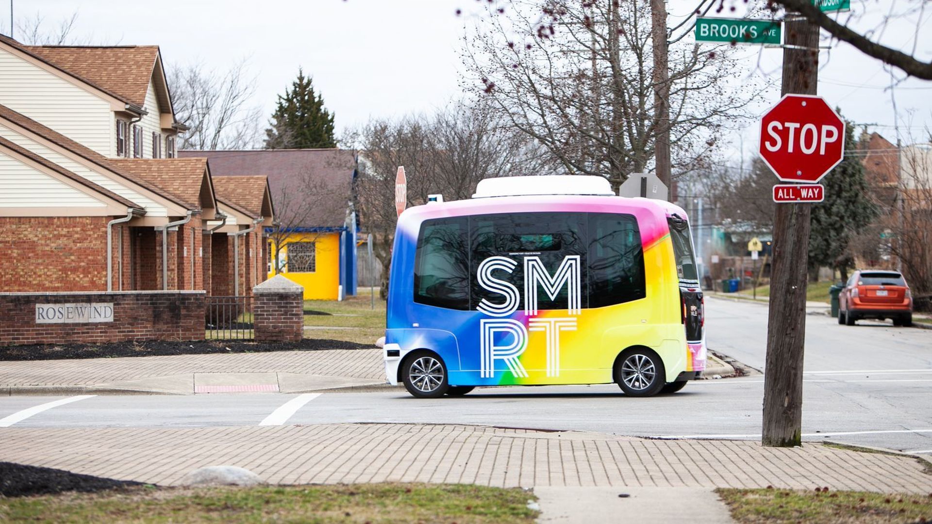 A photo of Columbus' self-driving shuttle parked in a neighborhood