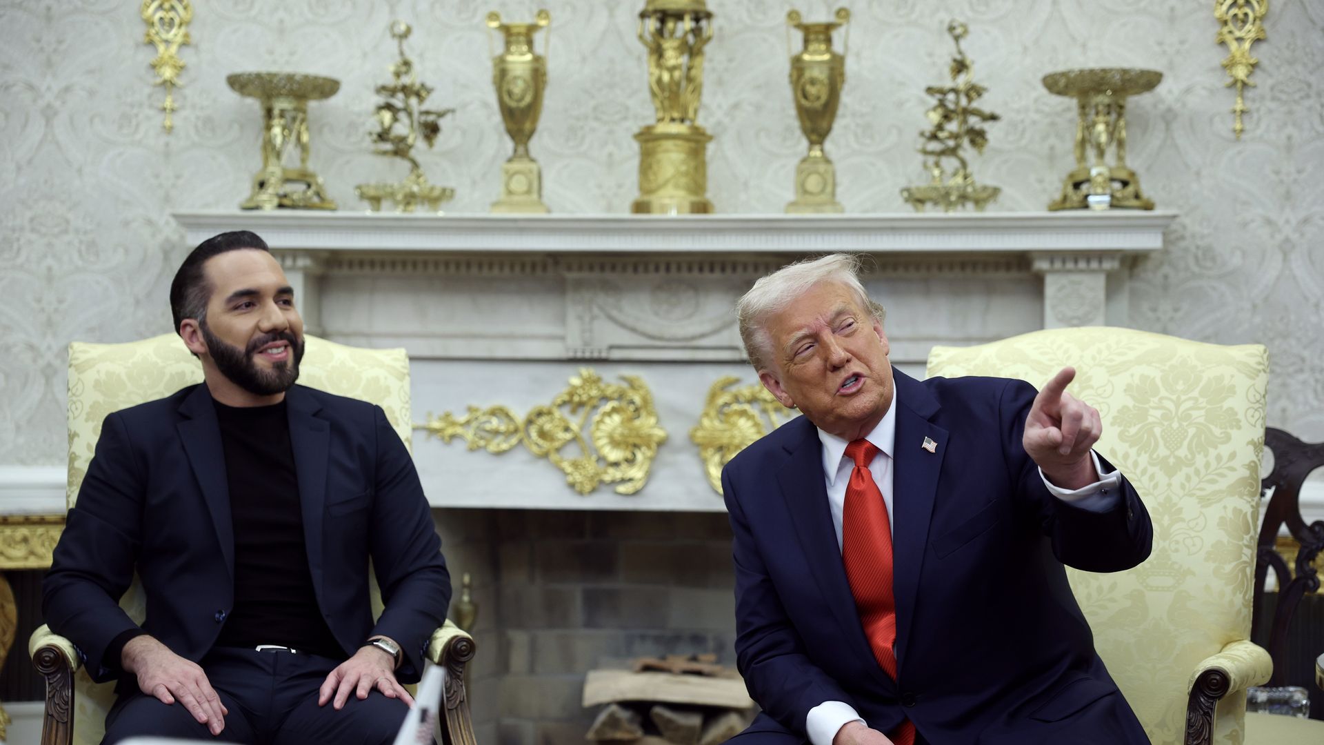 Nayib Bukele and Donald Trump sit next to each other in yellow gold chairs in the Oval Office 