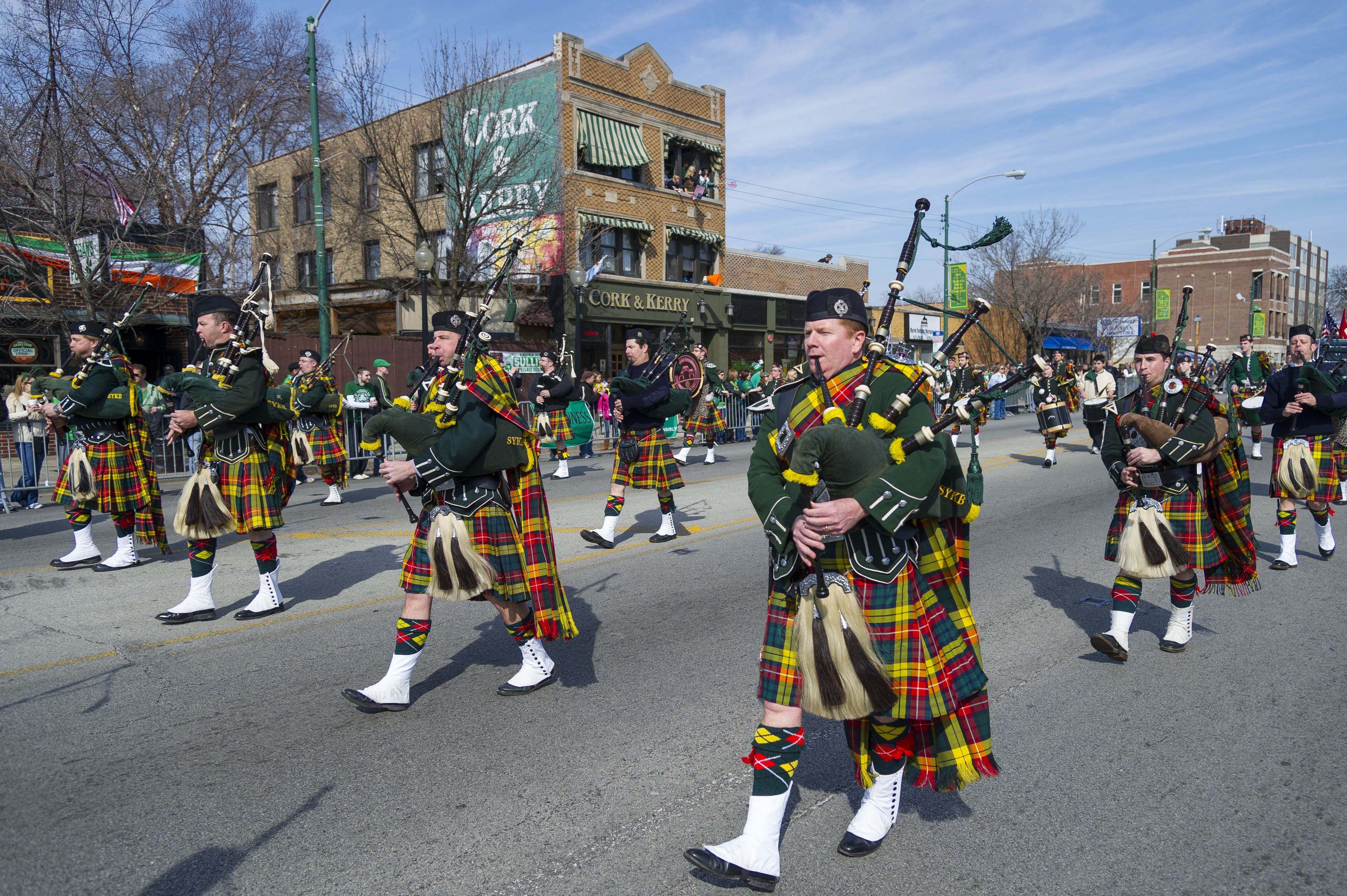 Photo of bagpipers marching in a parade. 