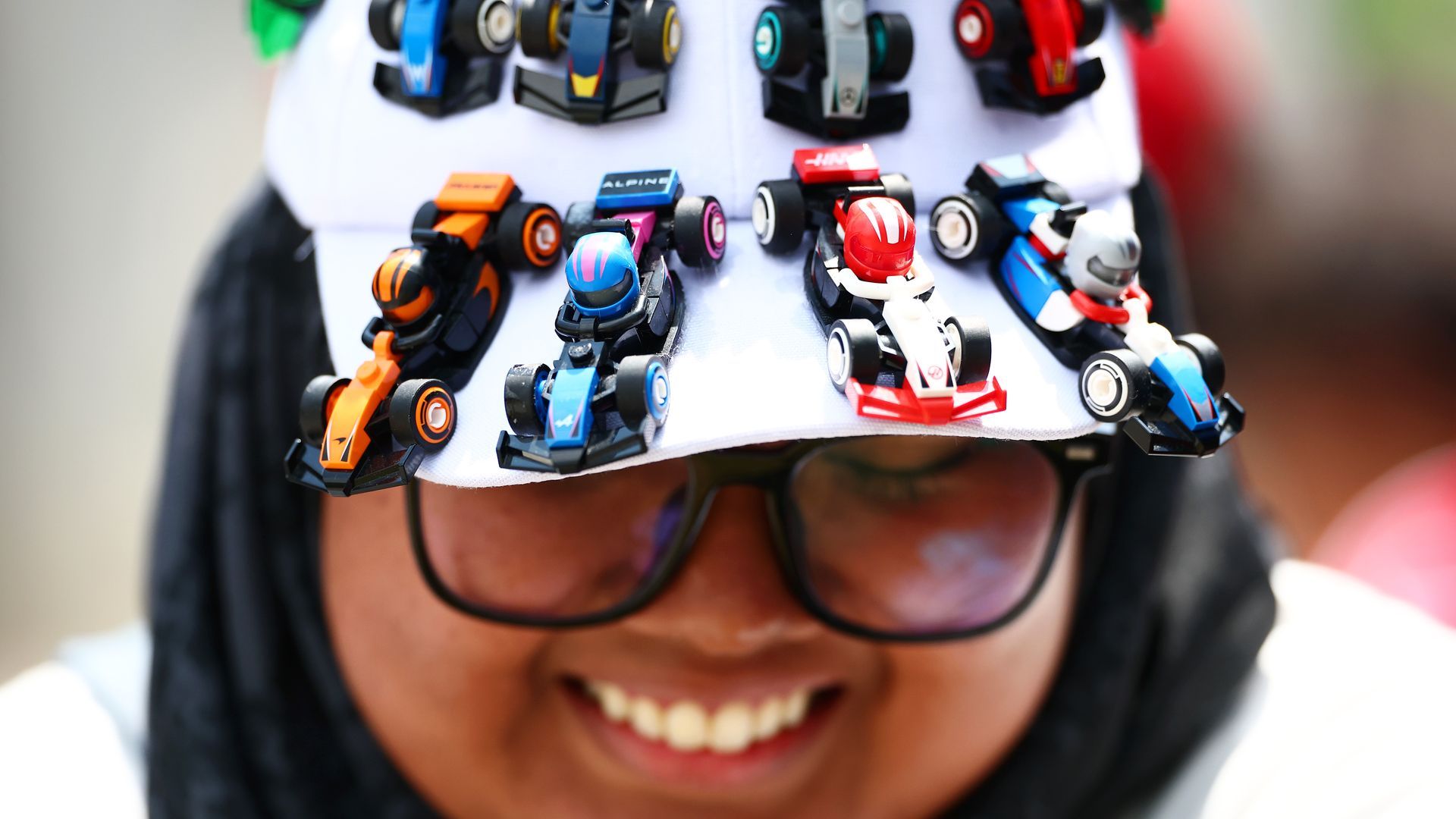 Woman wearing hat with F1 figures