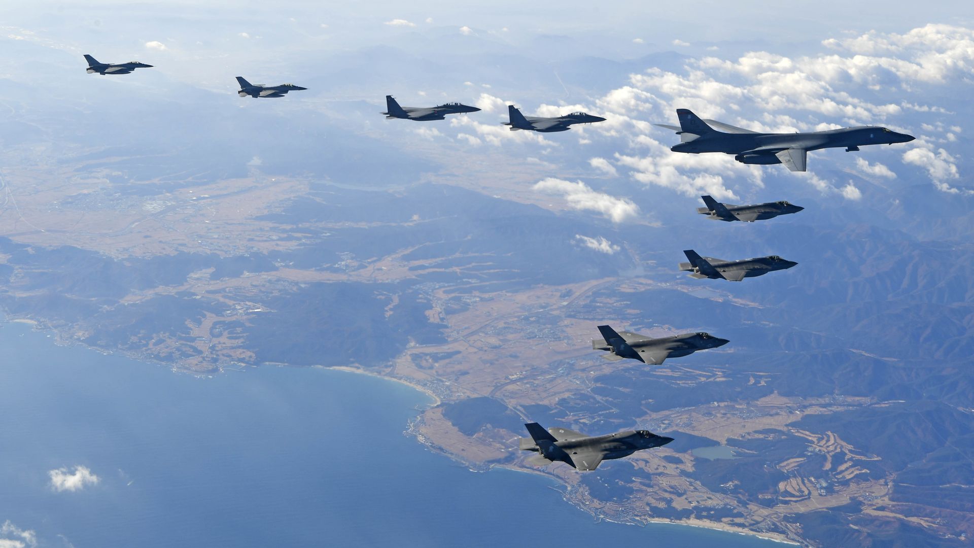 U.S. Air Force B-1B bomber flies over the Korean Peninsula with South Korean and U.S. fighter jets.