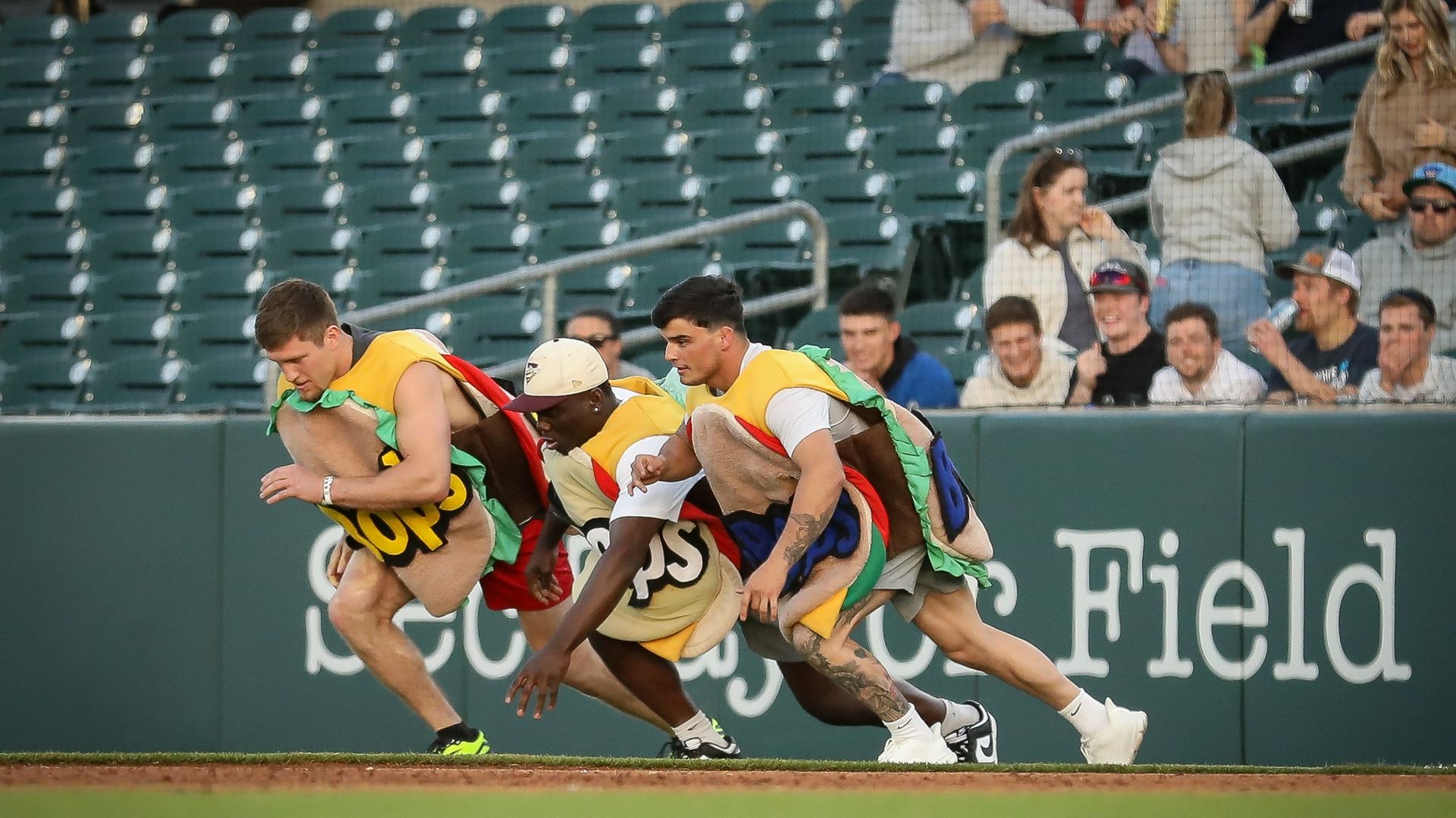 Men in hamburger suits running