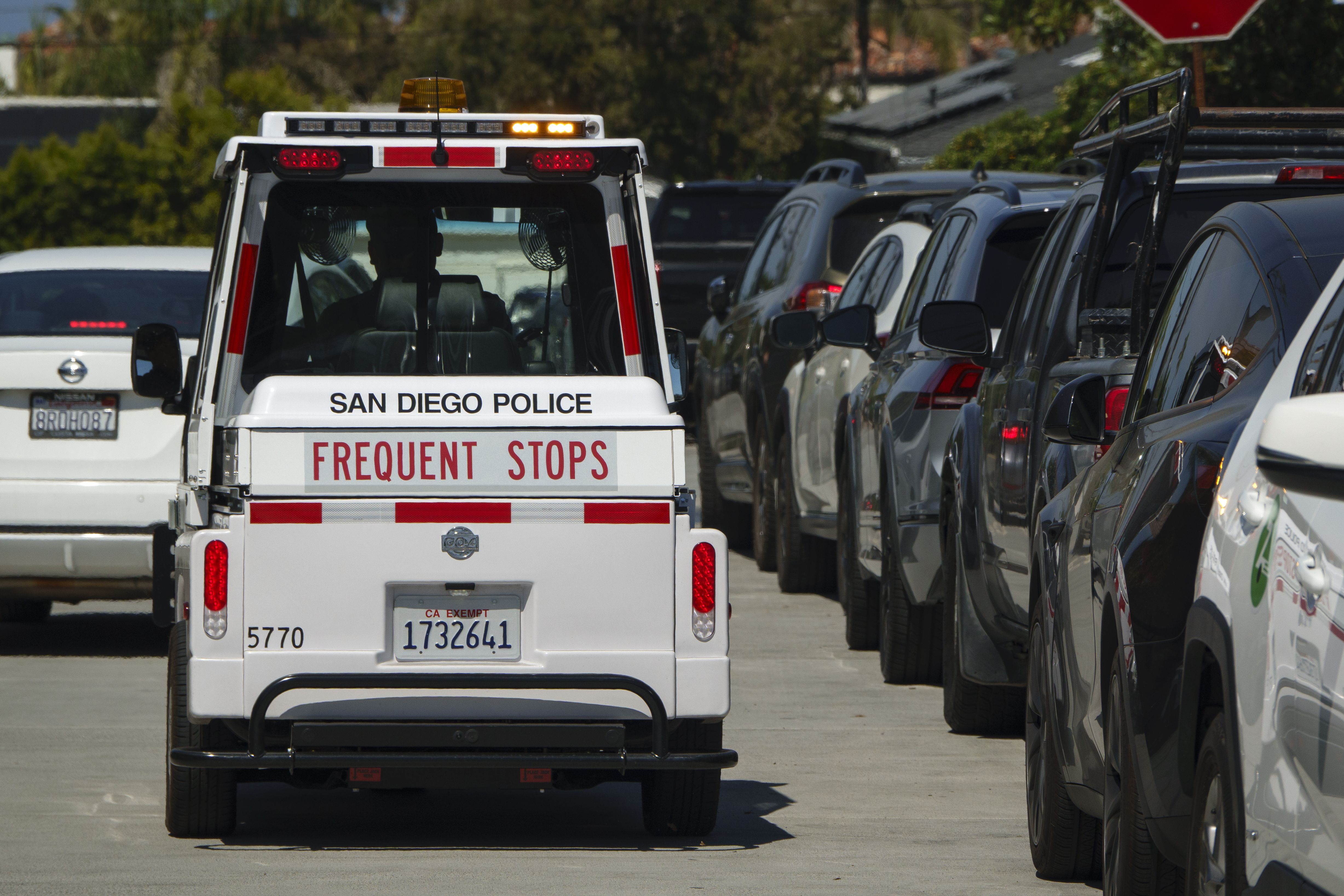 SAN DIEGO, CALIFORNIA - MARCH 21: A San Diego Police parking enforcement officer patrols on a crowded beach street in La Jolla on March 21, 2026 in San Diego, CA. (Photo by Kevin Carter/Getty Images)
