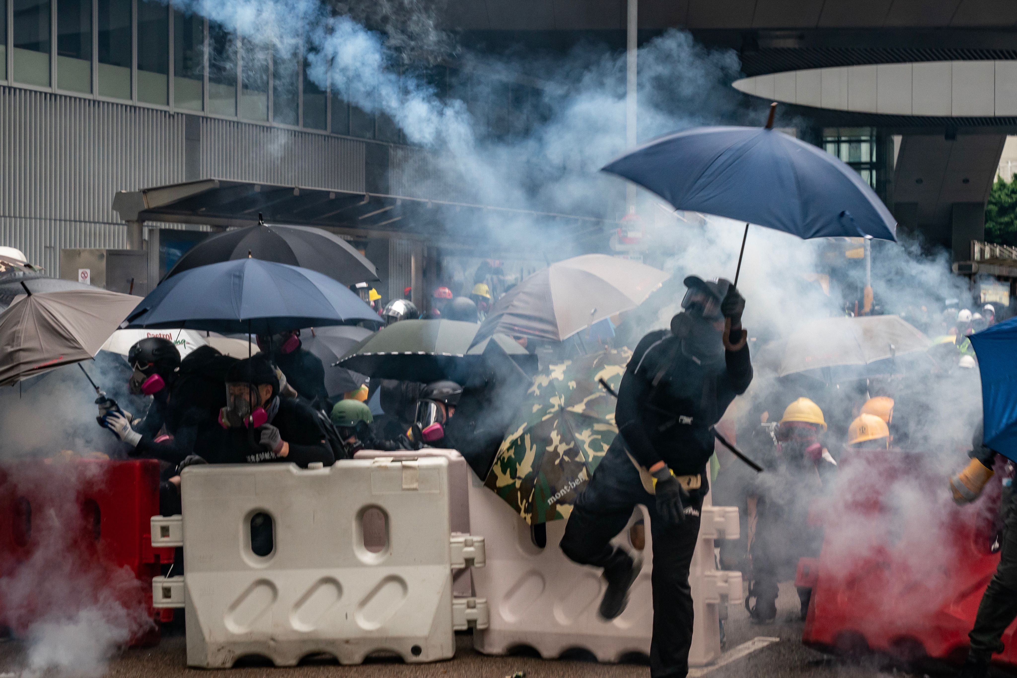 Protesters throw tear gas canisters back at police in Hong Kong