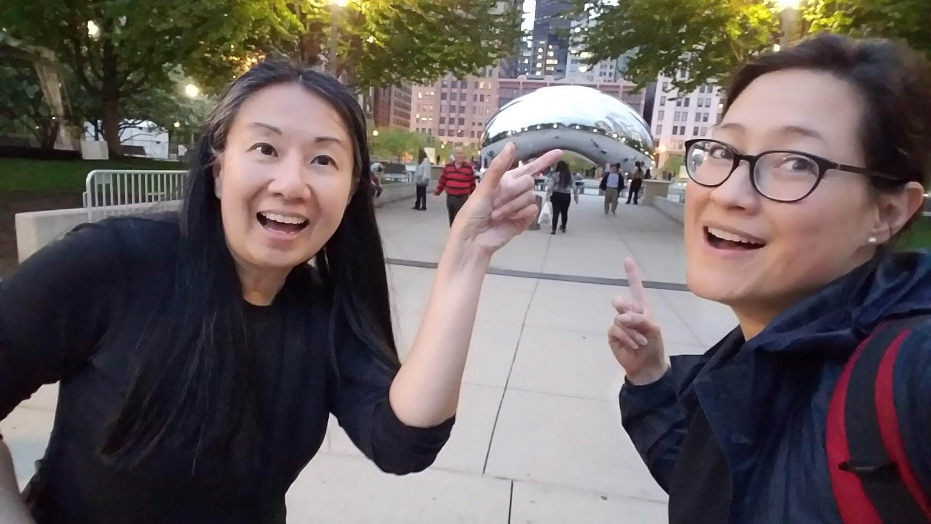 Louisa Chu & Monica Eng stand in front of the Bean in Chicago. 