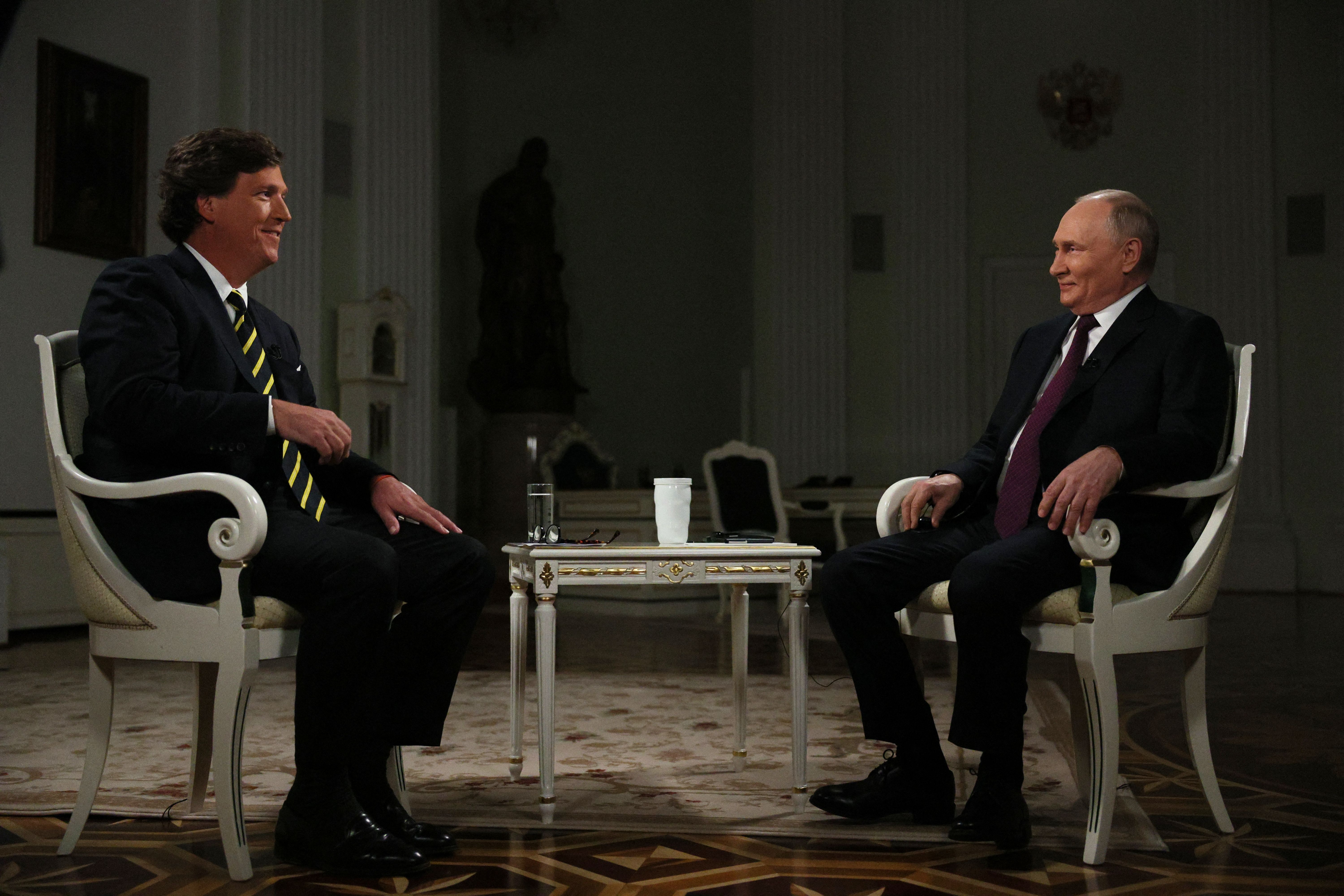 In this pool photograph distributed by Russian state agency Sputnik, Russia's President Vladimir Putin gives an interview to US talk show host Tucker Carlson at the Kremlin in Moscow on February 6, 2024.