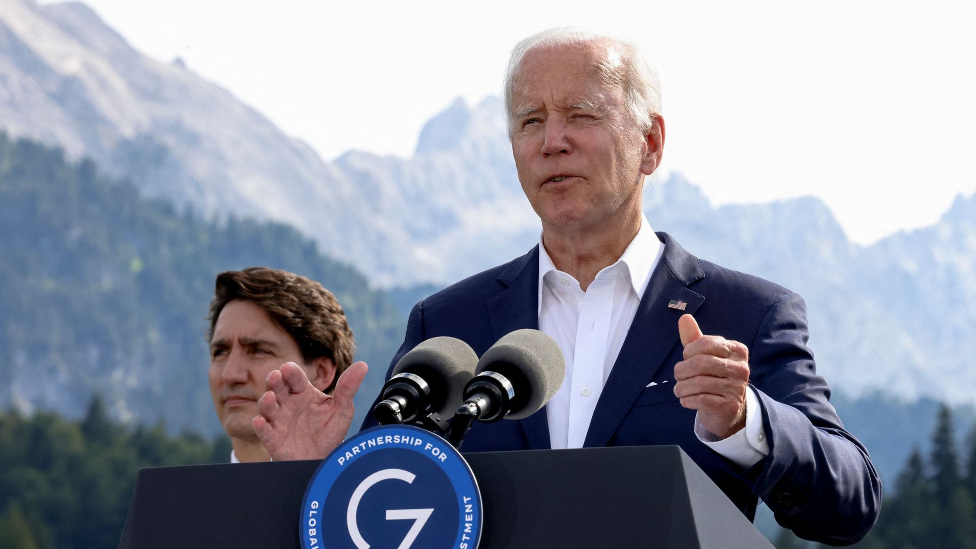 Joe Biden (R) addresses a press conference 