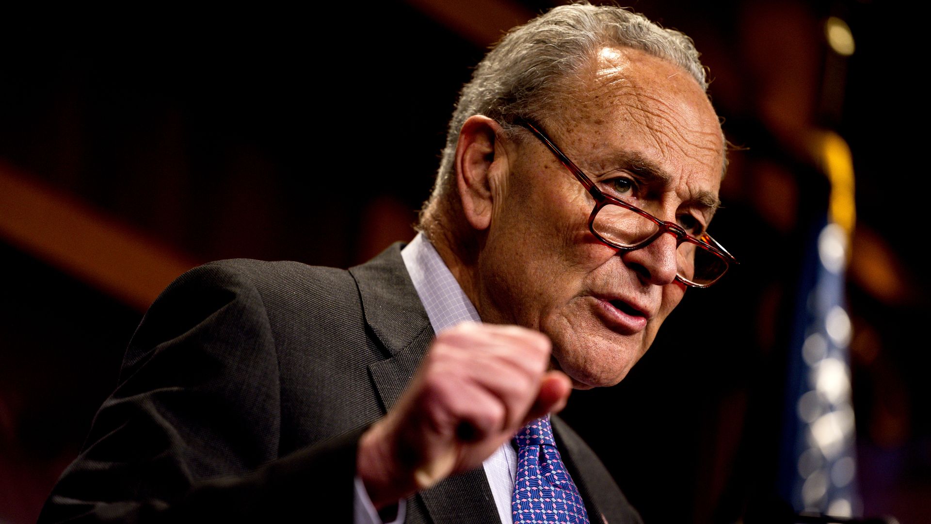 Sen. Chuck Schumer, wearing a purple tie and glasses