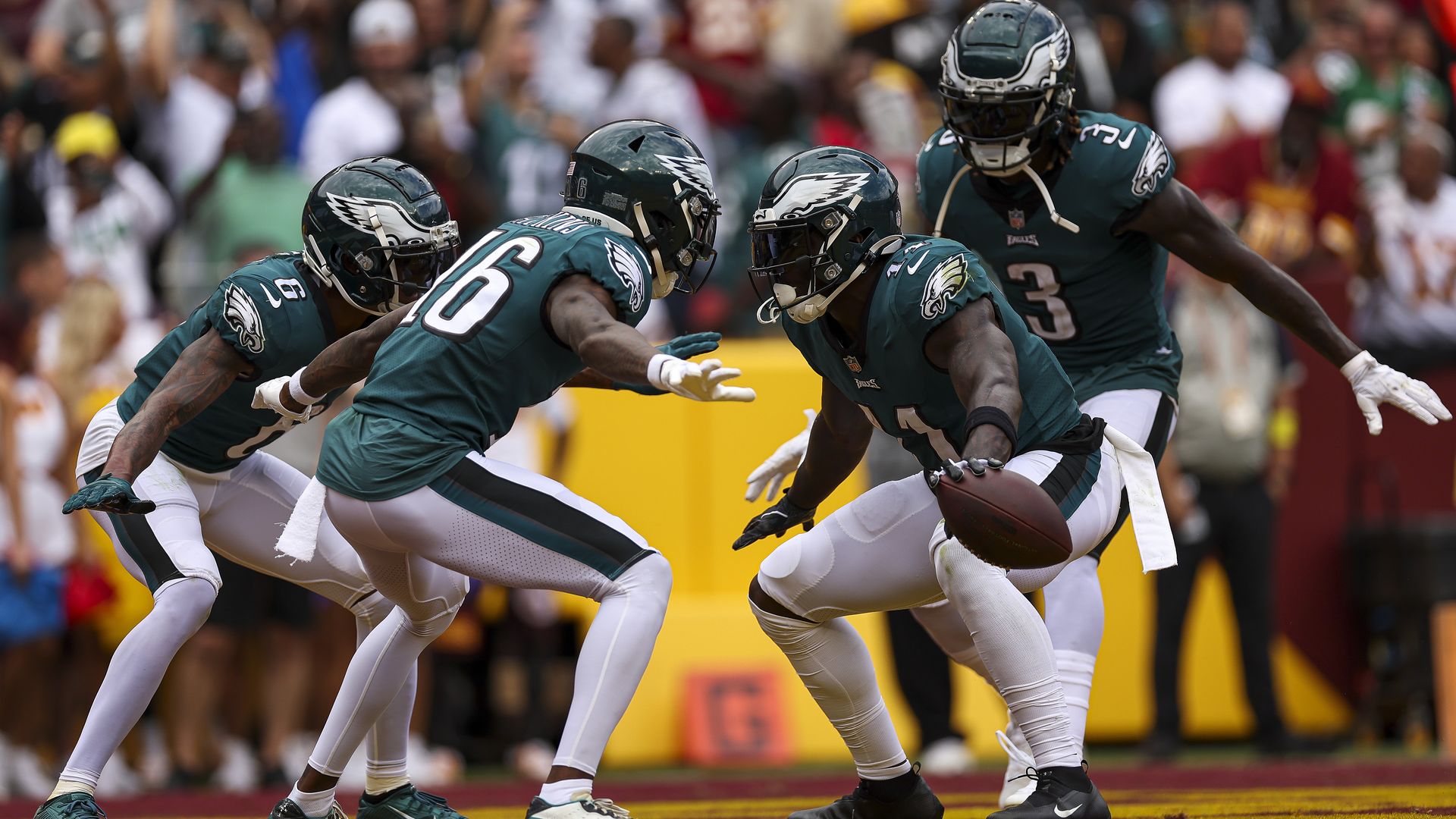 A group of Eagles player celebrate in the end zone.