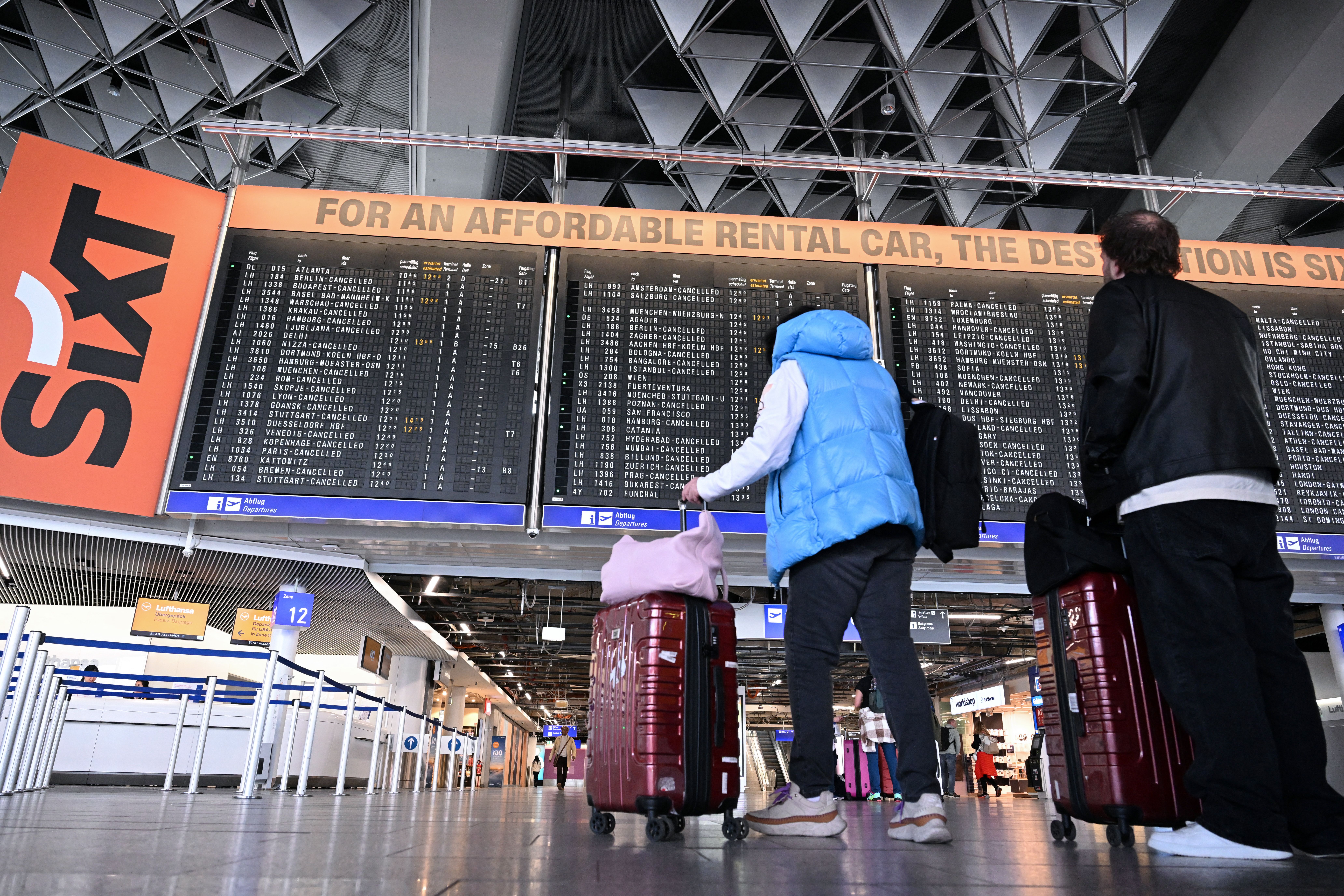 Passengers check for flight info at Germany's Frankfurt Airport yesterday. Photo: Kirill Kudryavtsev/AFP via Getty Images