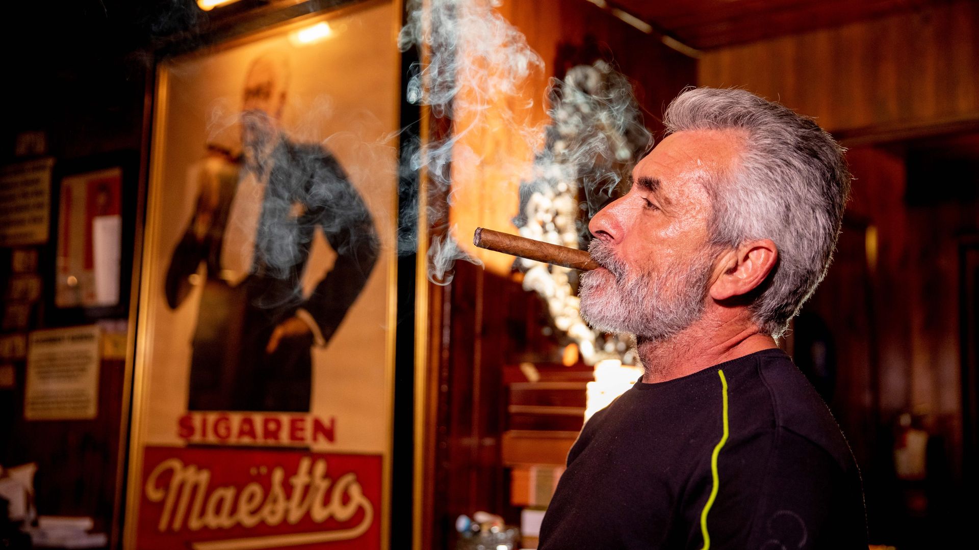 Rigo Fernandez, owner of Buena Vista Cigar Club, smokes a cigar in his lounge in Beverly Hills, California, May 21, 2019.