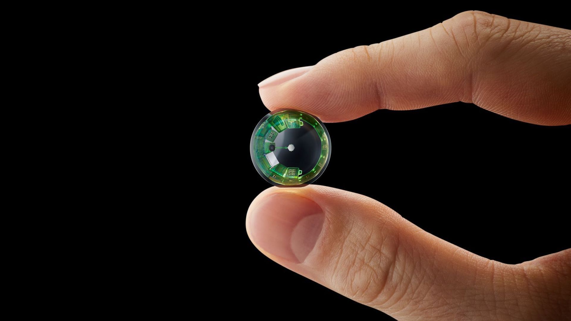 a smart contact lens being held in between two fingers