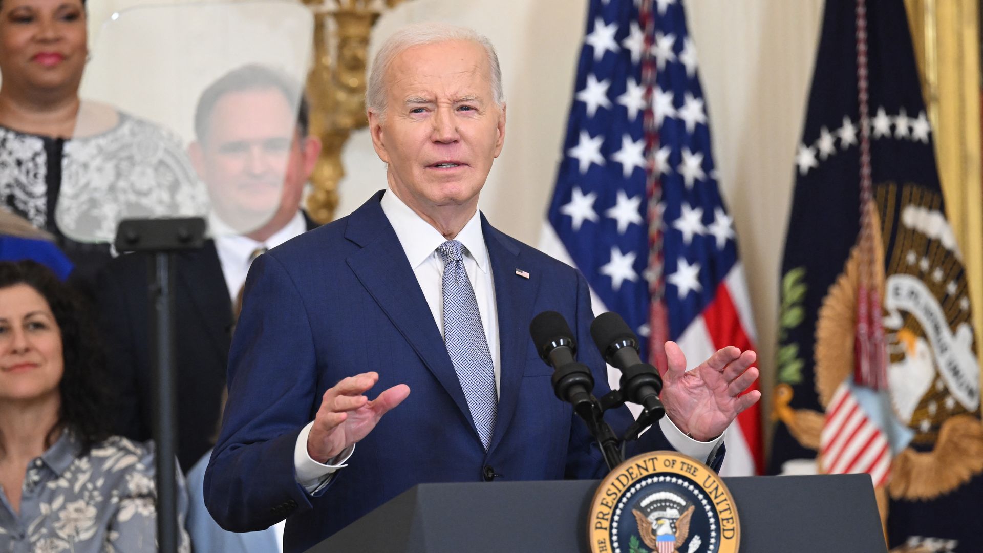 President Biden, wearing a blue suit, white shirt and blue tie.