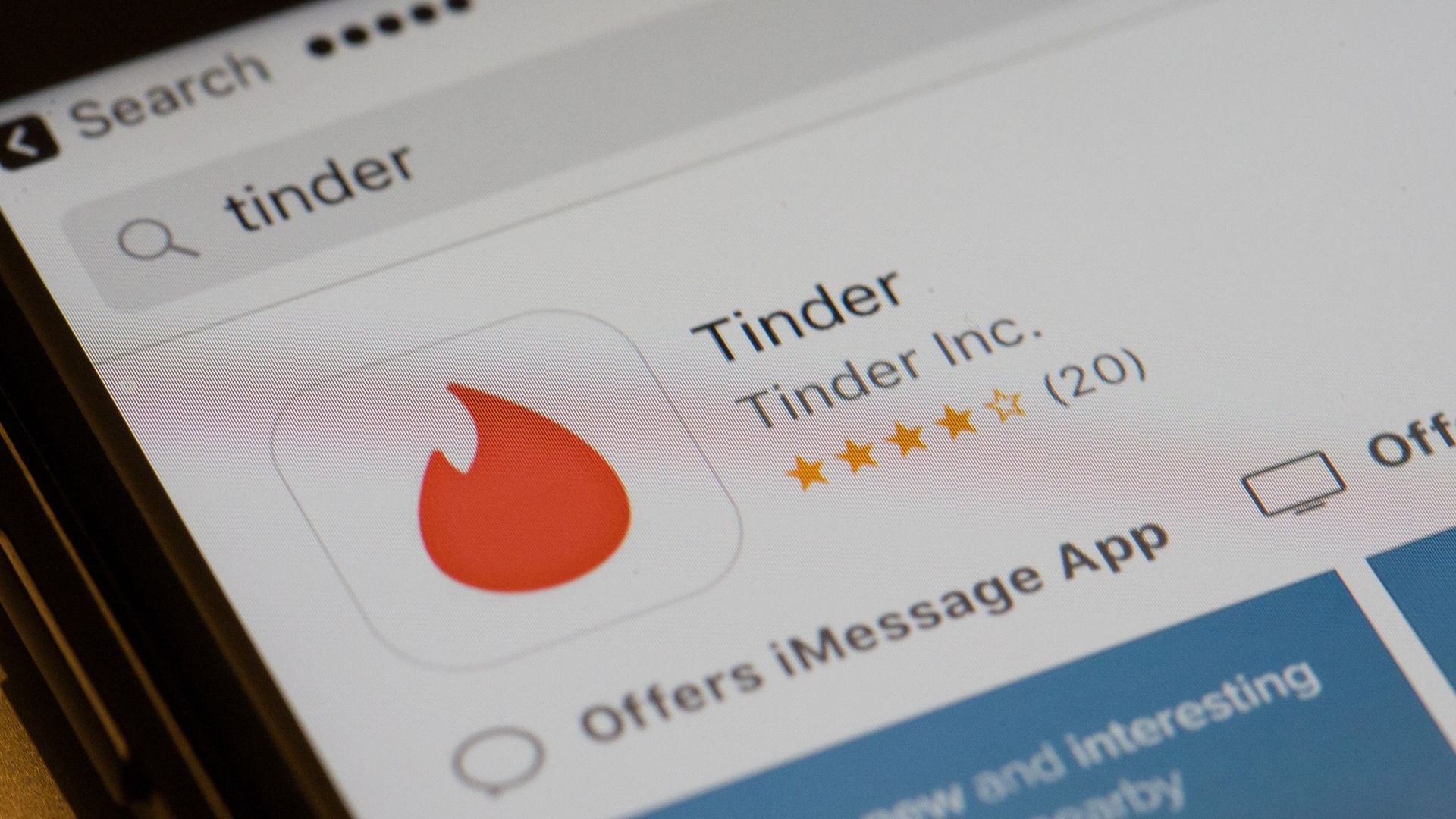 The Tinder app icon is shown in the app store