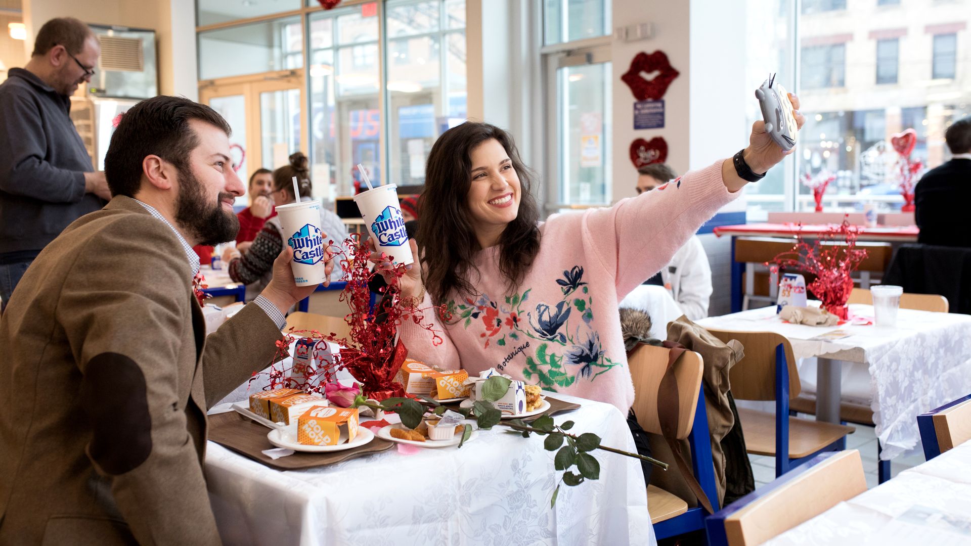 People taking a selfie with White Castle cups.