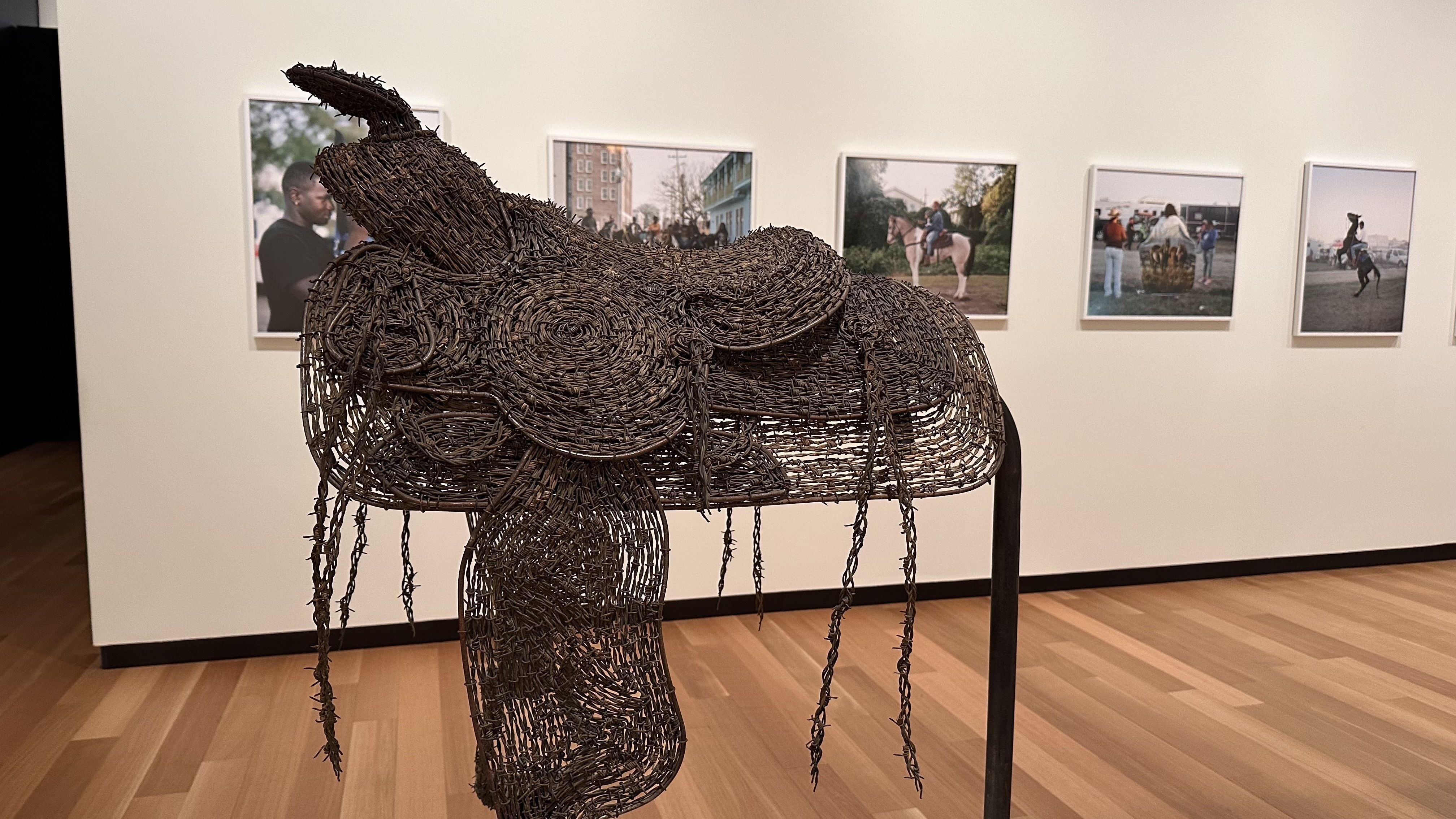 A photo of a saddle made from barbed wire in a museum display 
