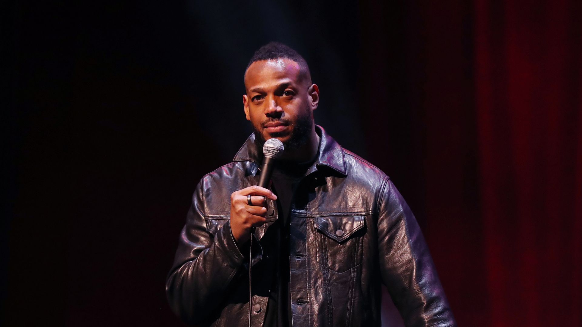 Marlon Wayans performs on stage. 