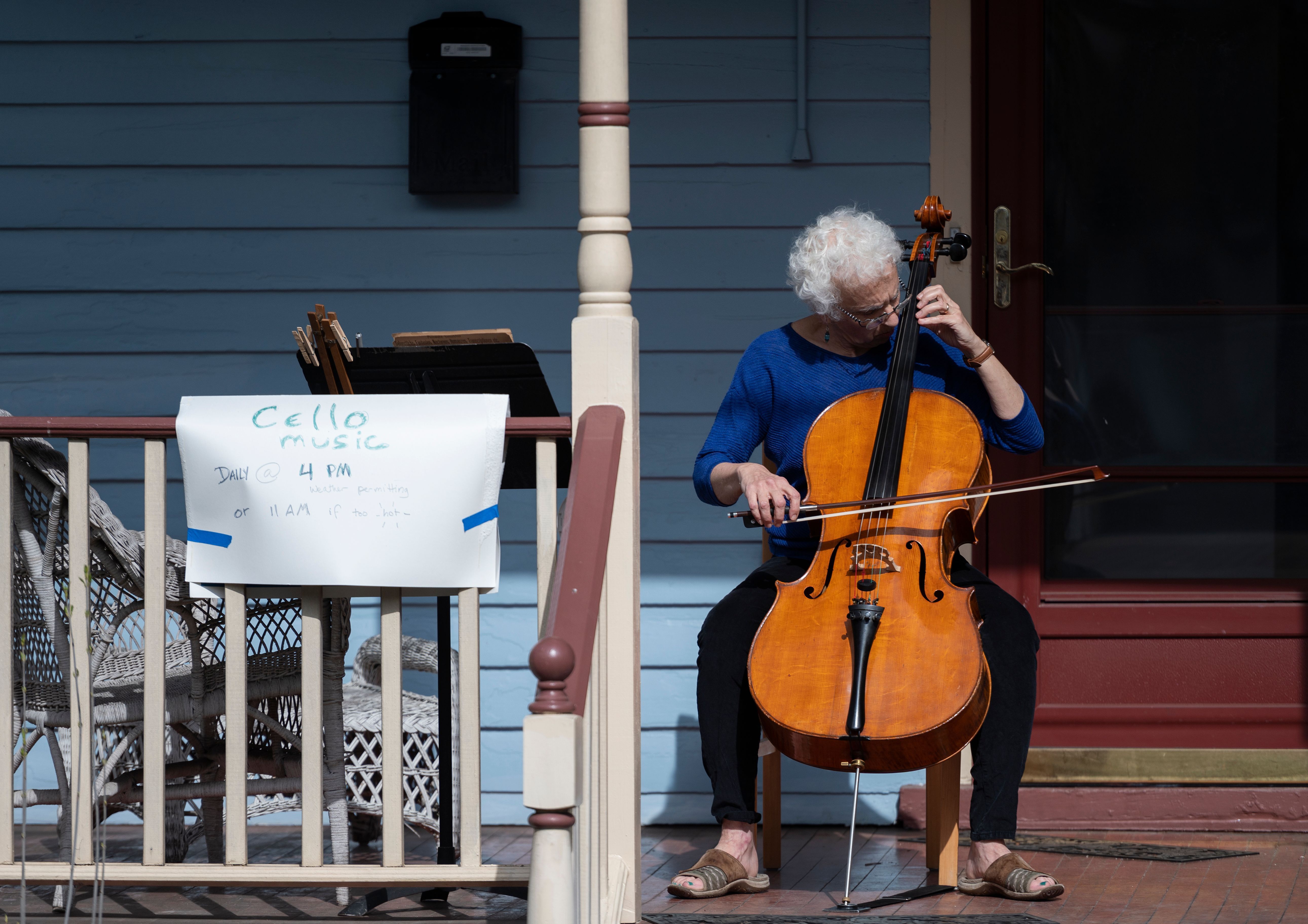 Cellist Jodi Beder performs a daily concert on her front porch in Mount Rainier, Maryland, to help people passing by and her neighbors cope with the outbreak. 