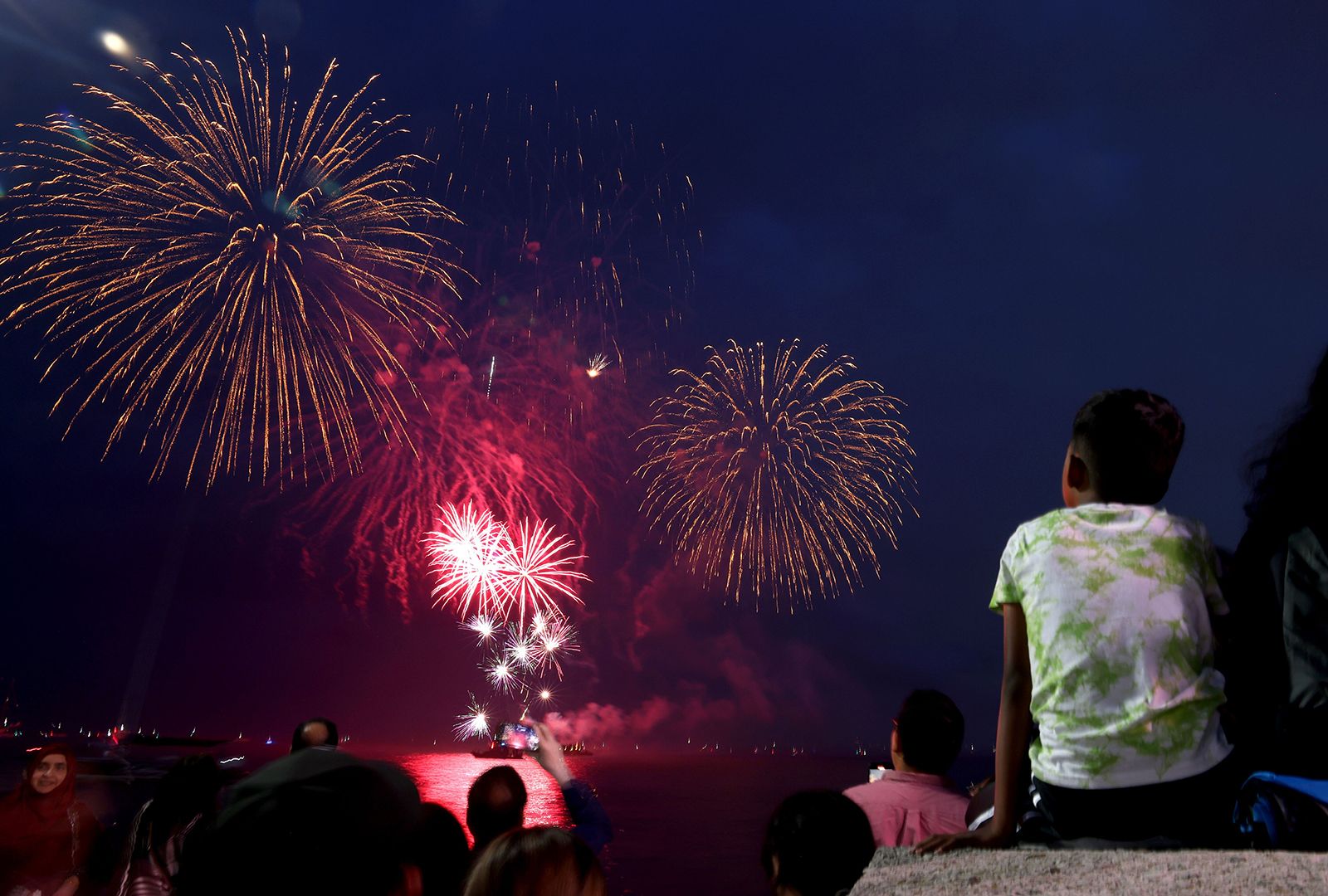 People watch from Navy Pier in Chicago as fireworks are set off on July 1, 2023, to celebrate the Fourth of July weekend. 