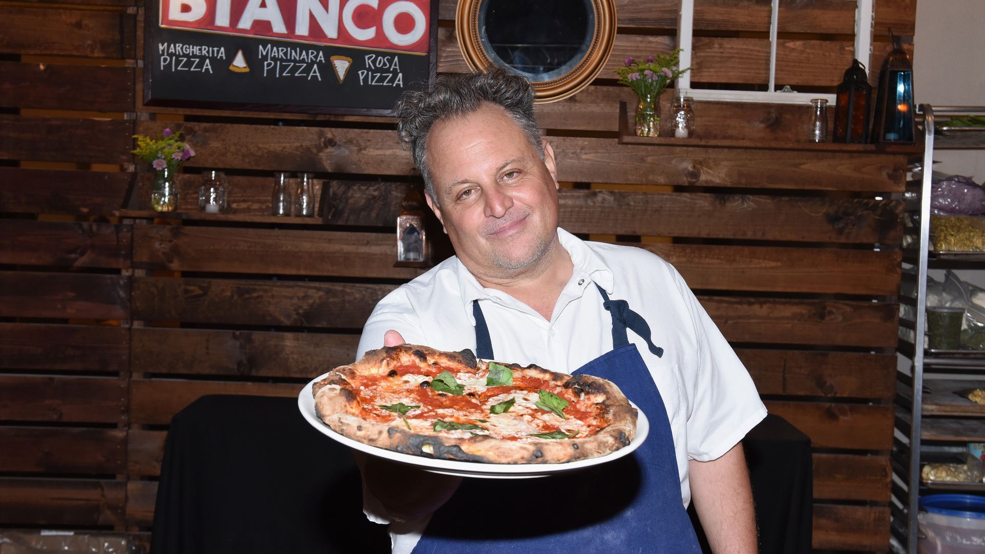 chris bianco holding a pizza