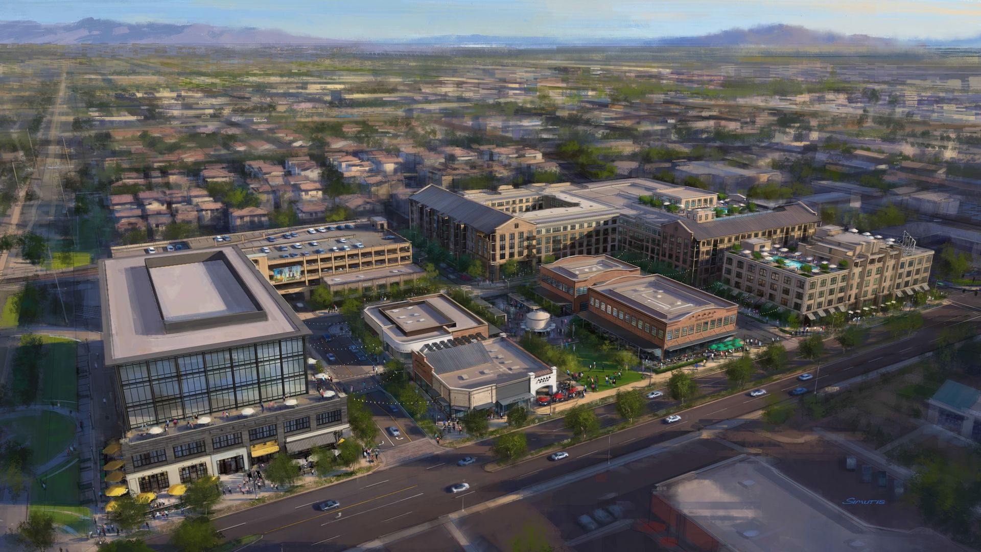 An aerial view of a modern urban campus with a large glass-front building in the foreground, brick and beige offices, busy streets, cars, and a surrounding residential area with distant mountains.