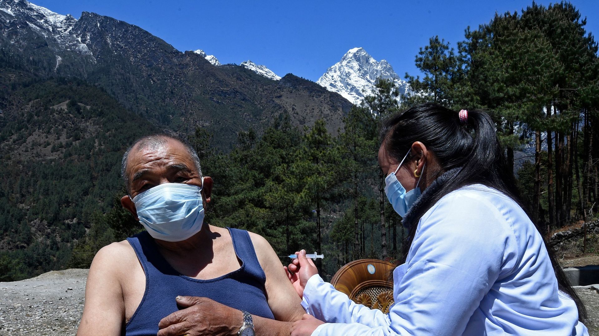 A health worker inoculates a man with the dose of Covishield vaccine against the Covid-19 coronavirus at a health post near Lukla on April 23
