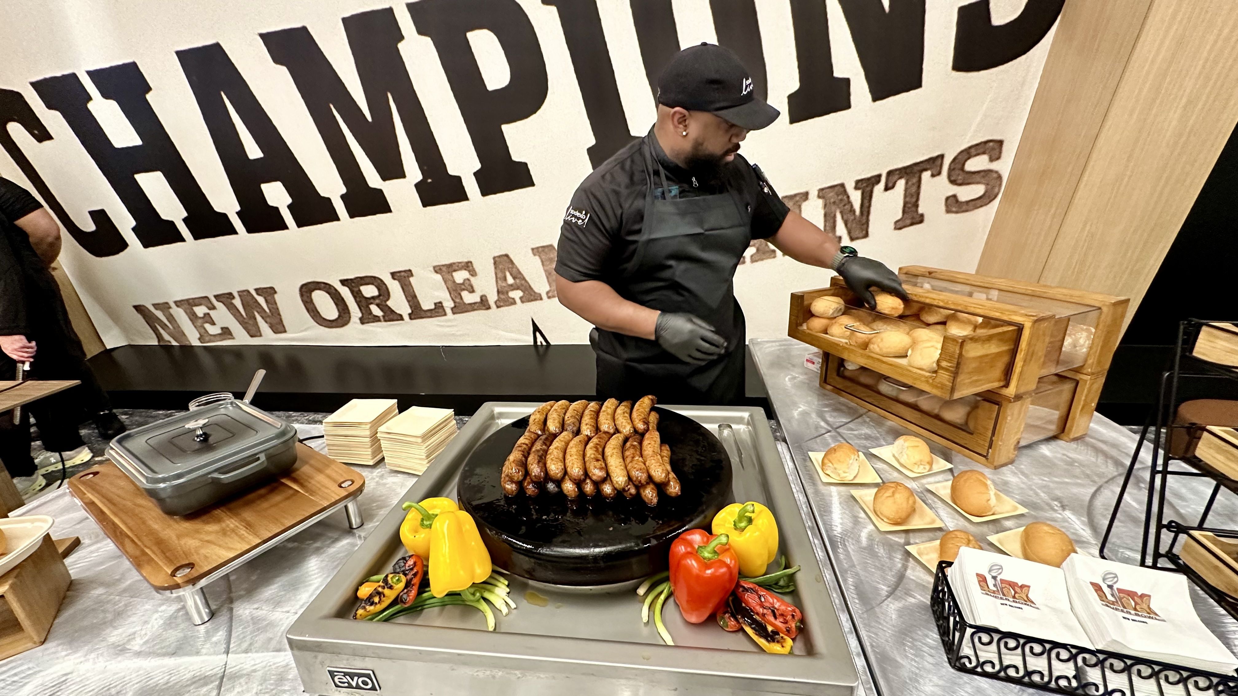 Photo shows a man with alligator sausages.