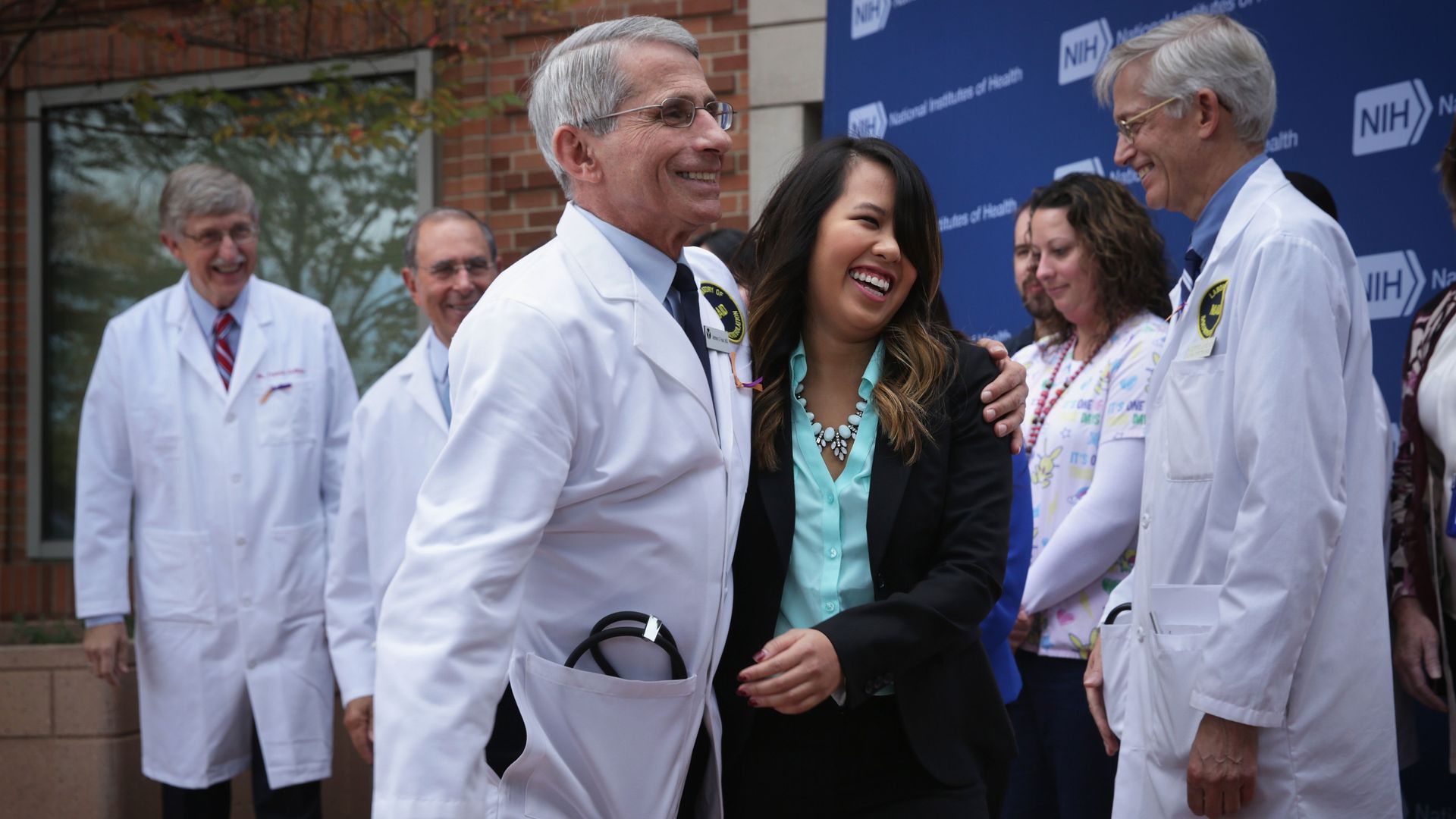 In this image, Fauci laughs while walking with a doctor