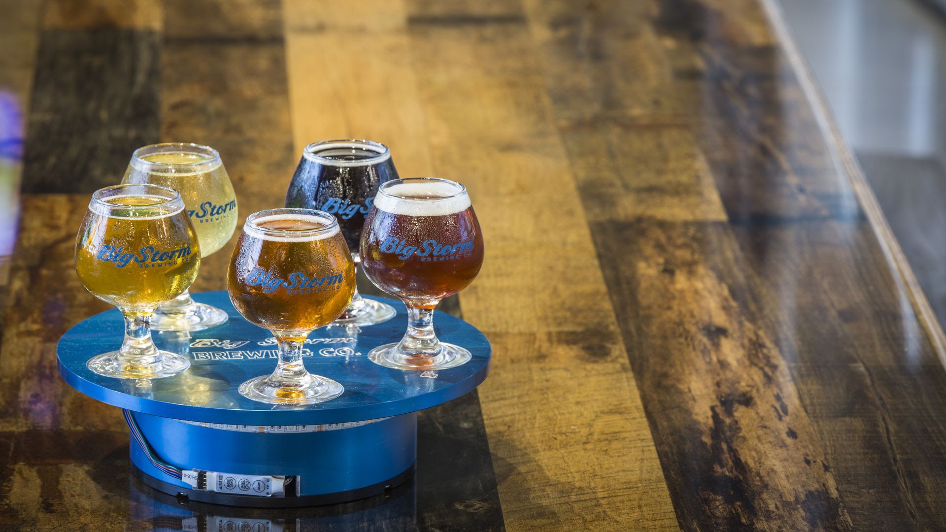 A round of Big Storm Beer sits on a wooden table.