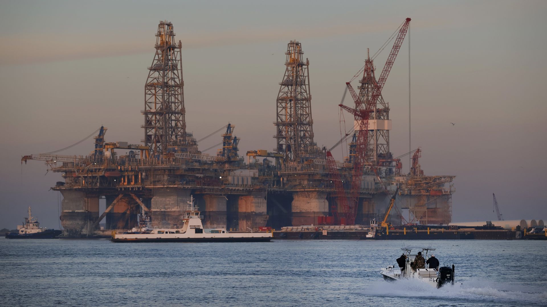 Tug boats prepare to tow the semi-submersible drilling platform Noble Danny Adkins through the Port Aransas Channel into the Gulf of Mexico on December 12, 2020 in Port Aransas, Texas.