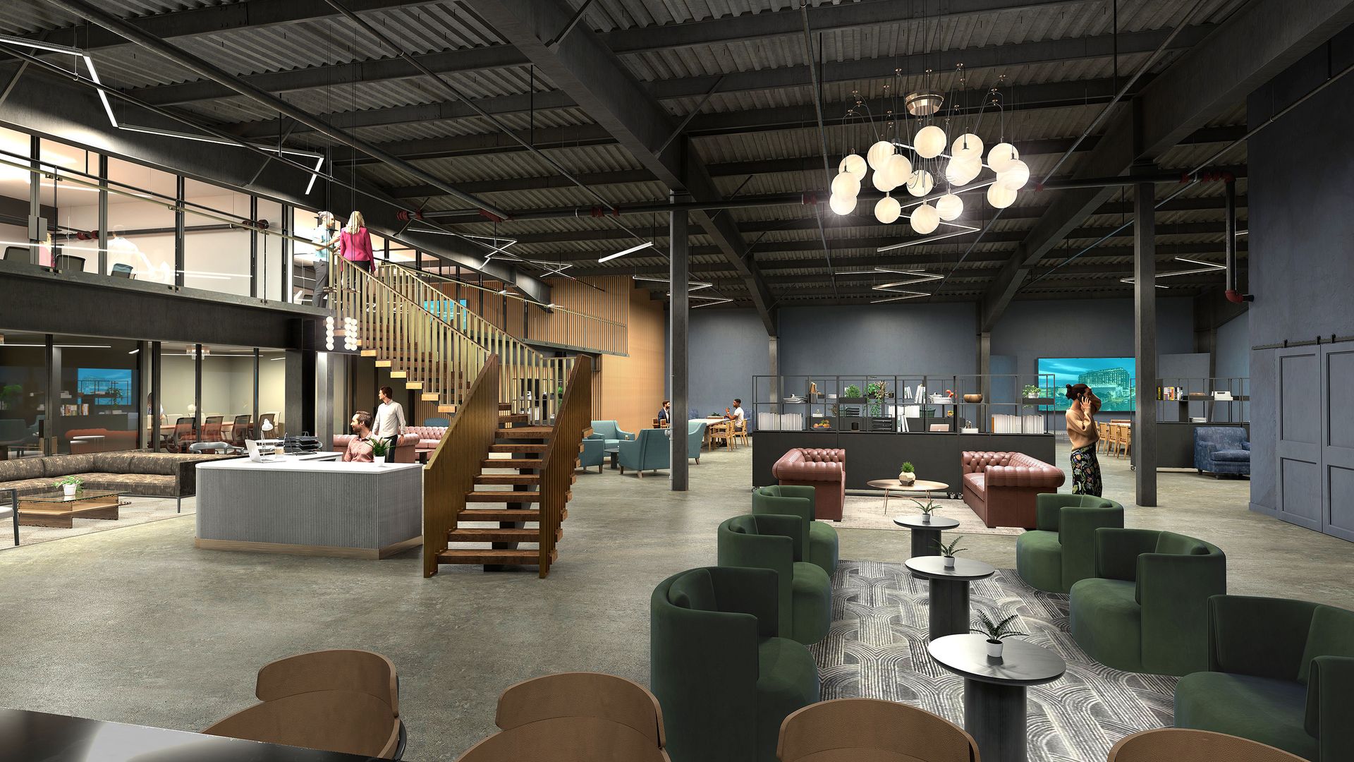 A coworking space with an open floor plan and lounge seating, with a staircase to a mezzanine