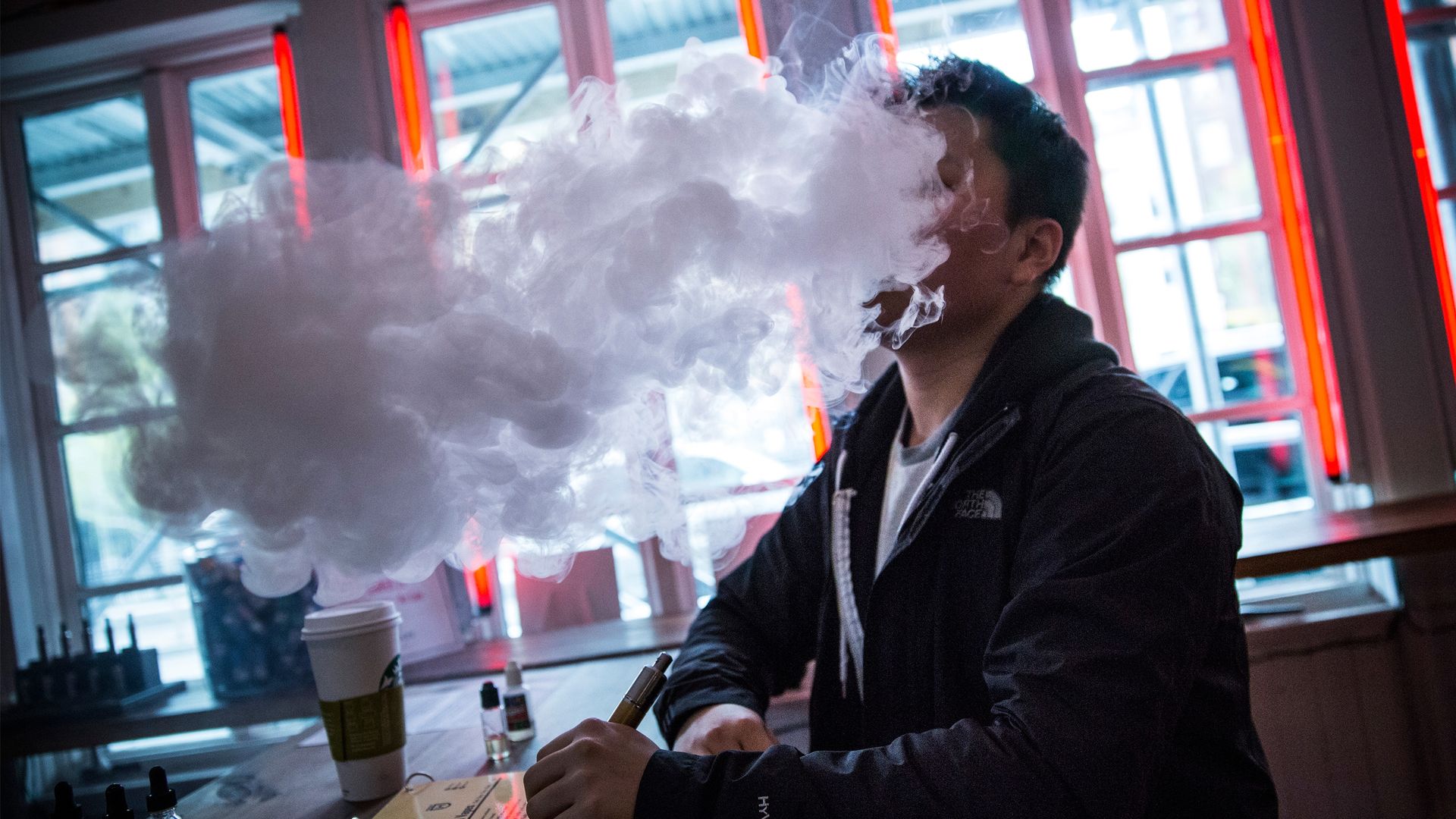 Man vaping in a coffee shop