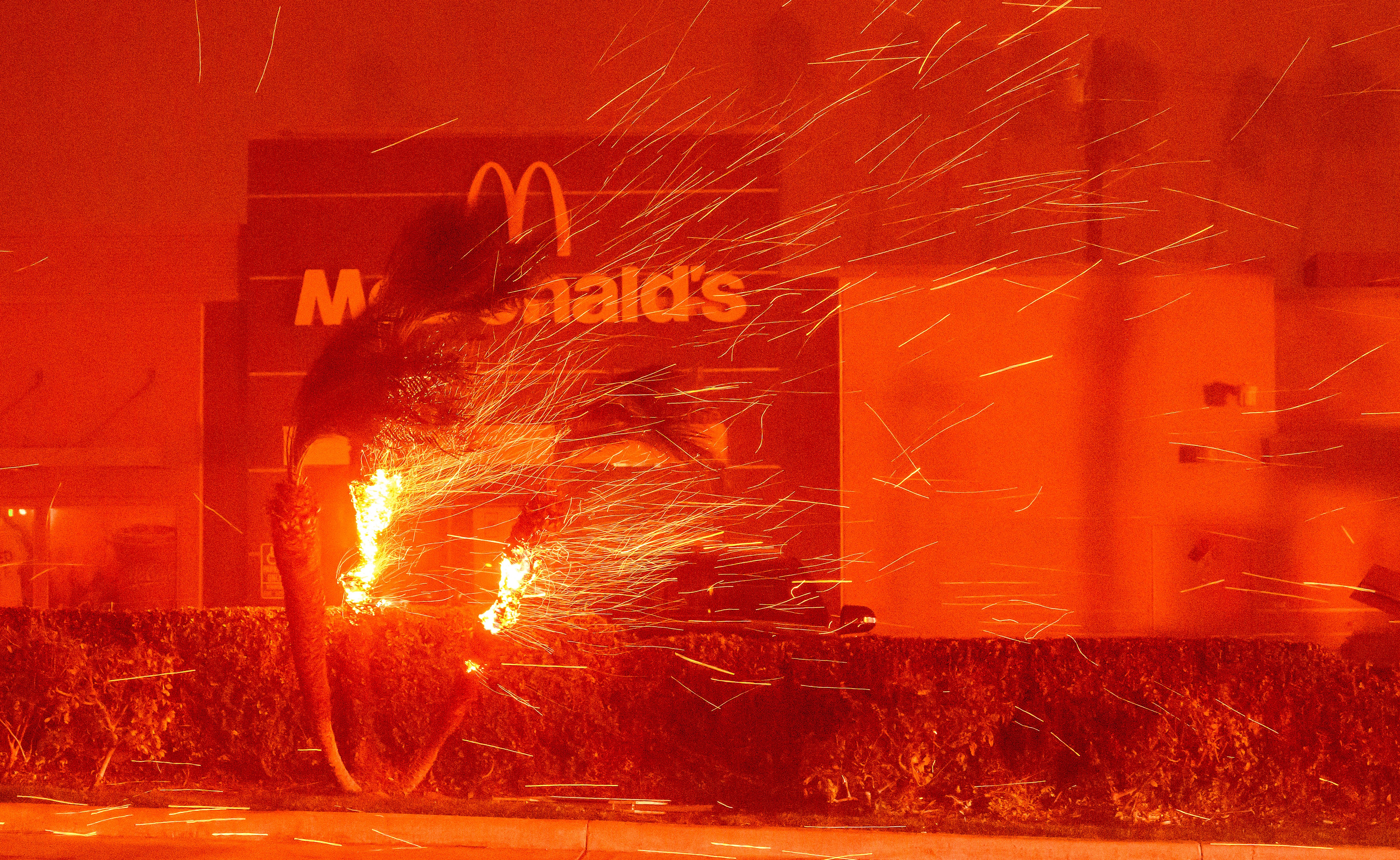  A McDonald's restaurant is showered in embers during the Eaton fire in Pasadena, California on January 7, 2025.