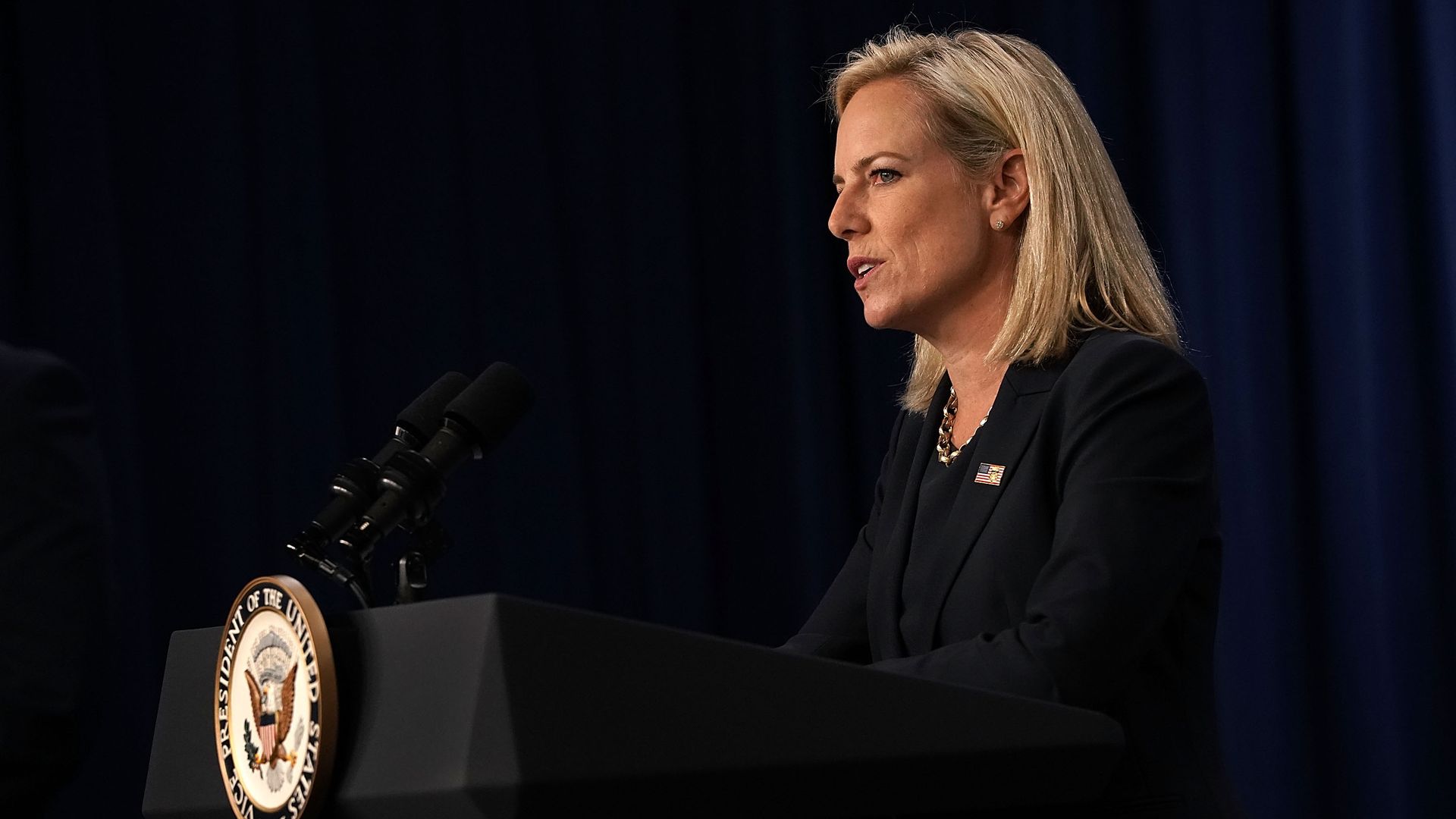 Kirstjen Nielsen speaking at a podium. 