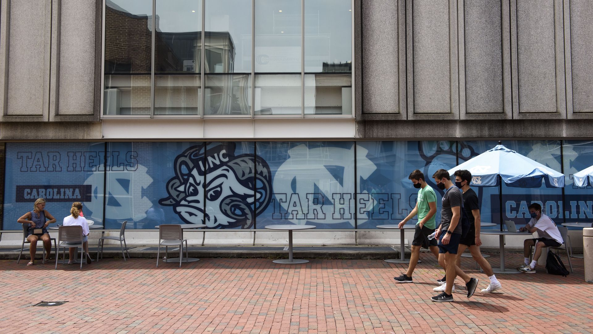 Students walk through the campus of the University of North Carolina at Chapel Hill on August 18, 2020 in Chapel Hill, North Carolina.
