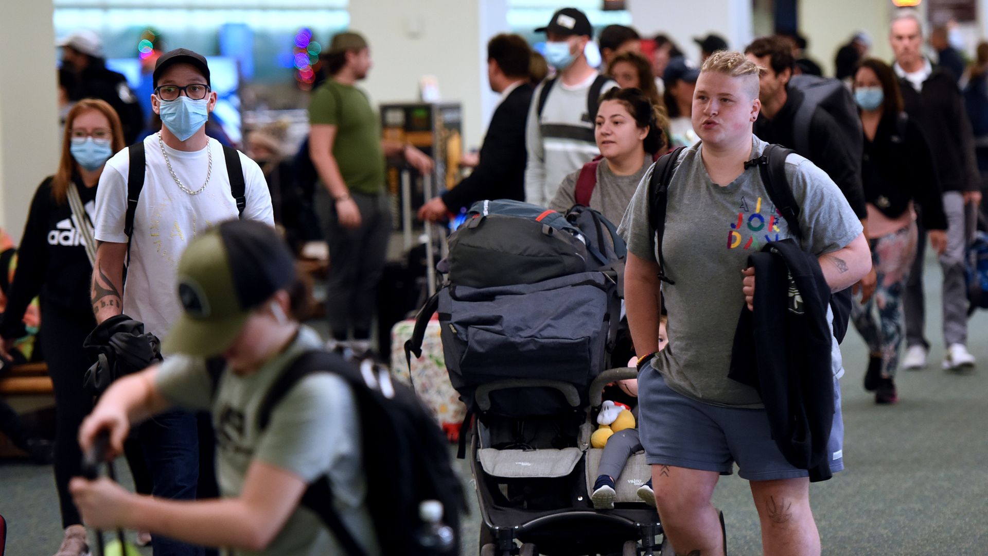 Travelers make their way through Orlando International Airport during the busy Christmas holiday season on December 28, 2022 in Orlando, Florida