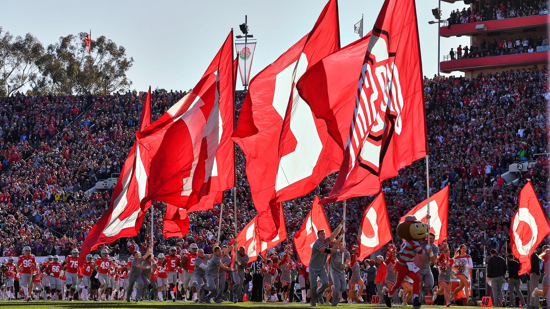 The Ohio State Buckeyes mascot leads cheerleaders and players onto the Rose Bowl field before a 2019 football game.