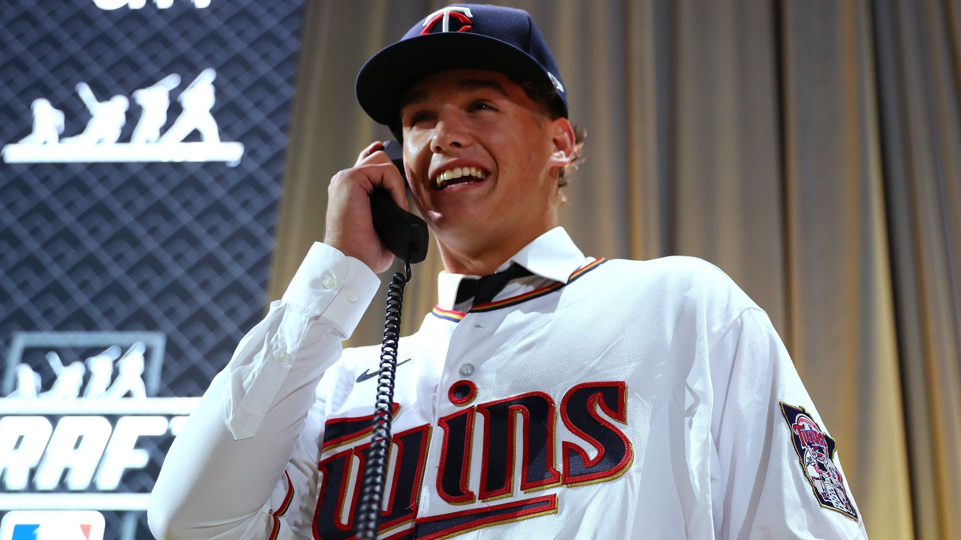 Minnesota Twins first-round pick Chase Petty smiles while answering the phone on MLB Draft night.