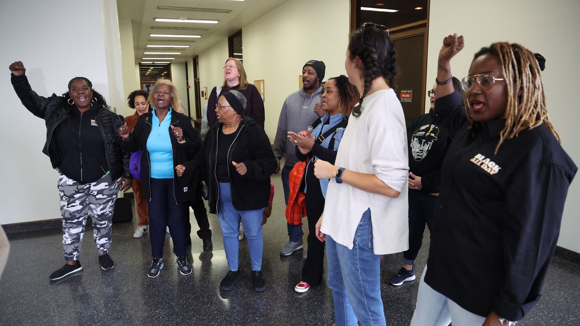 Photo of people shouting in a hallway